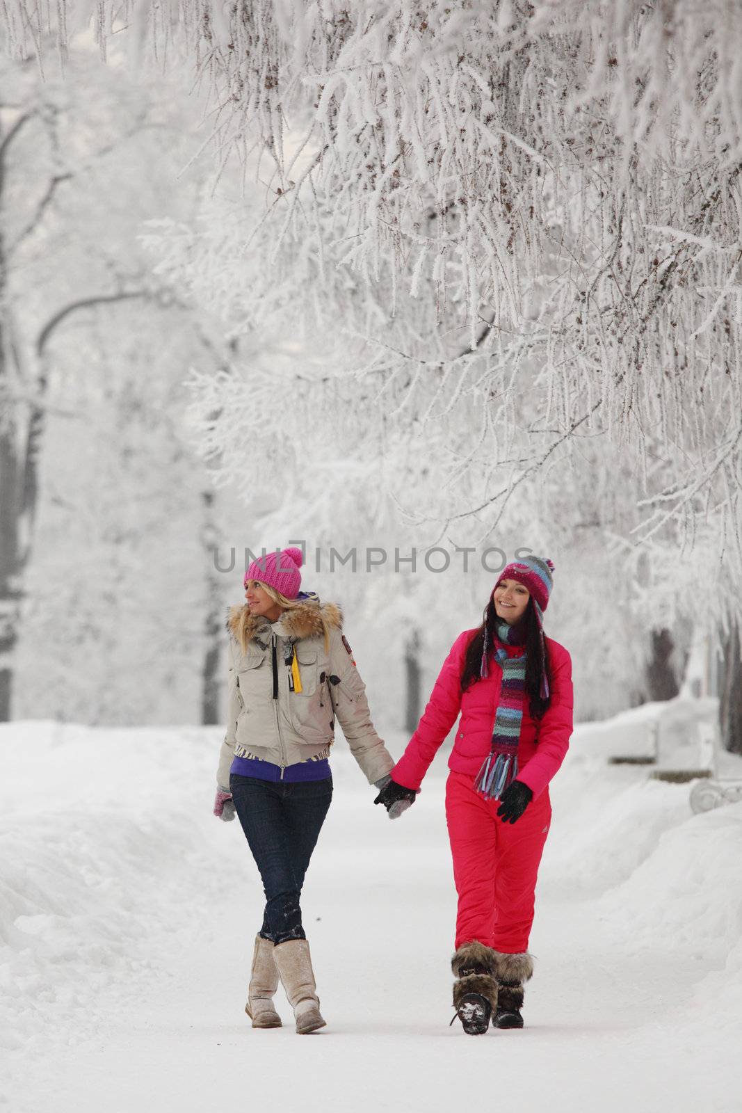 two winter women run by snow frosted alley