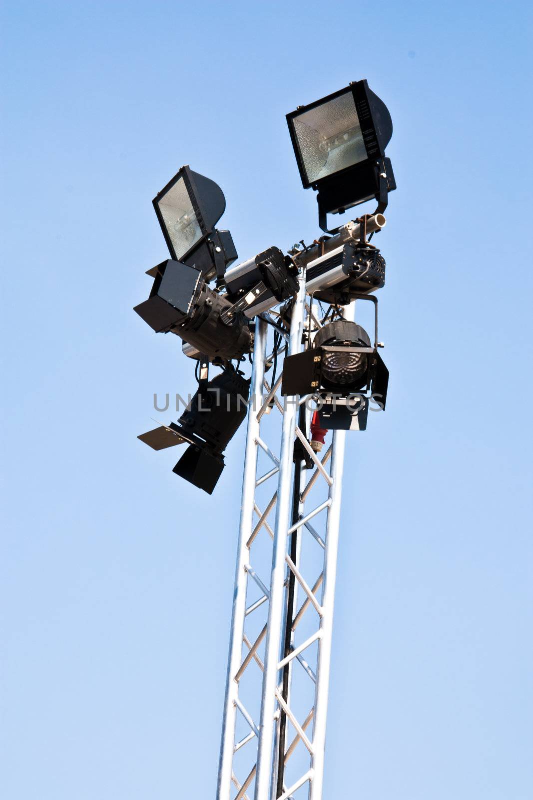 Spotlights mounted on steel poles. The sky in the background.