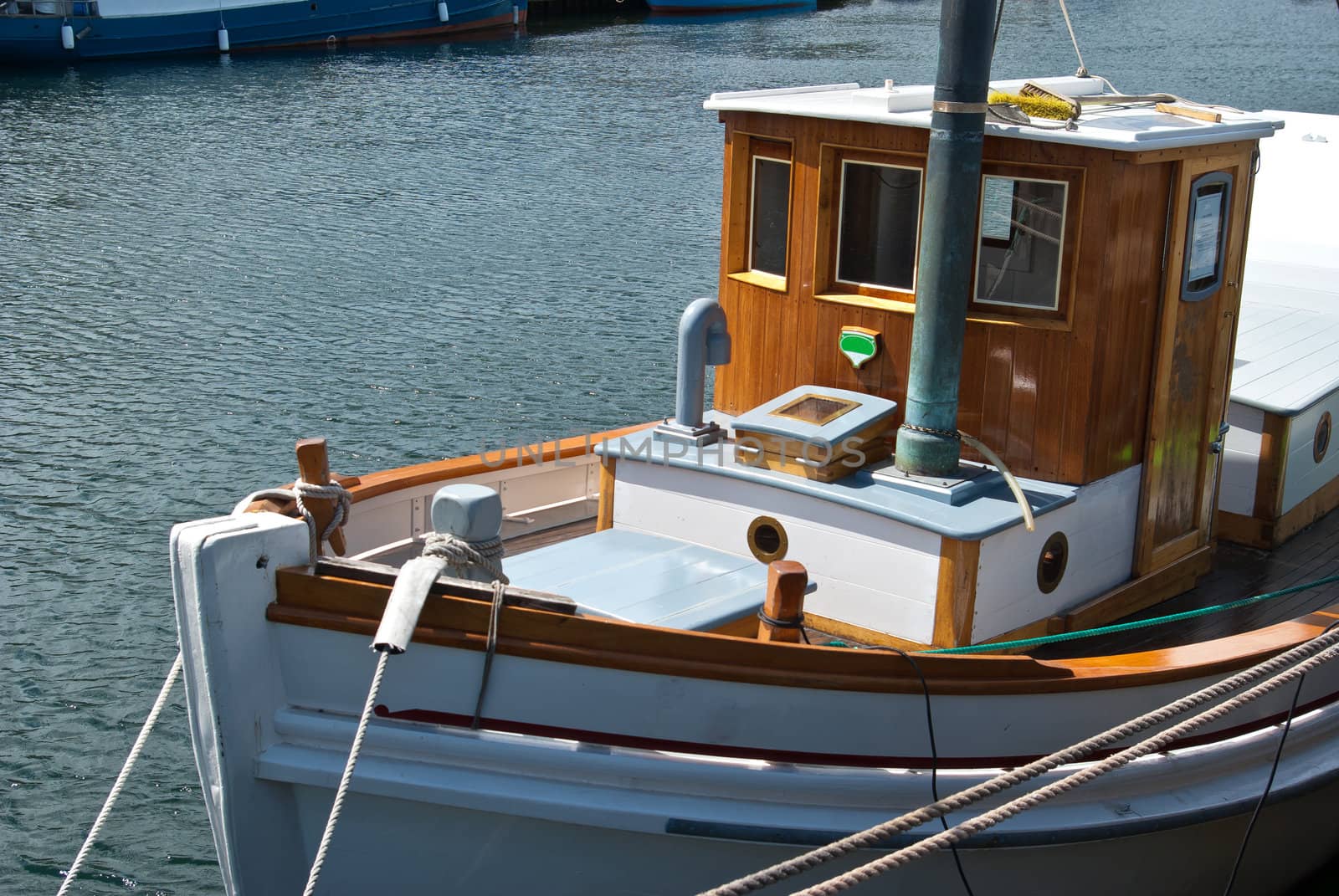 Beautiful classical design wooden sail yacht anchored  in a marina      