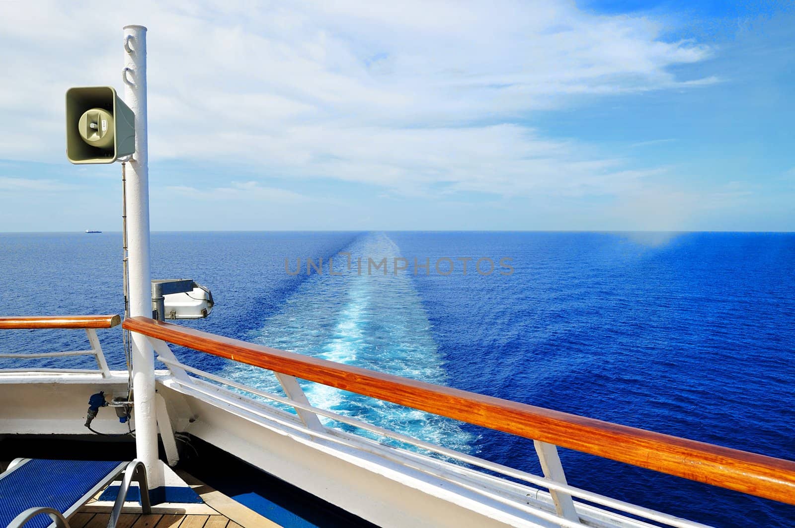 A cruise ship leaves a long wake in the Caribbean Sea near the Cayman Islands.