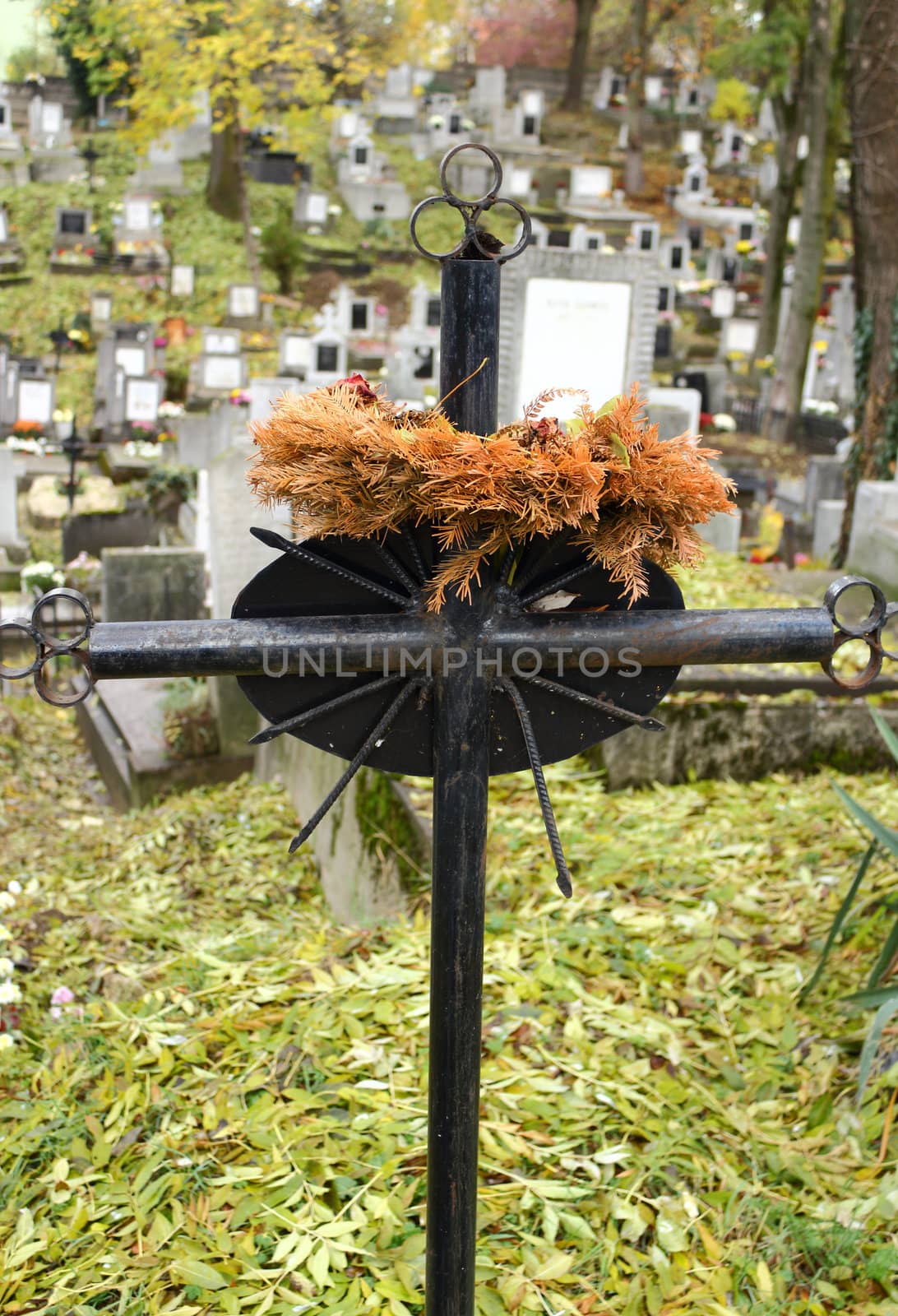 old black metal cross in the cemetery