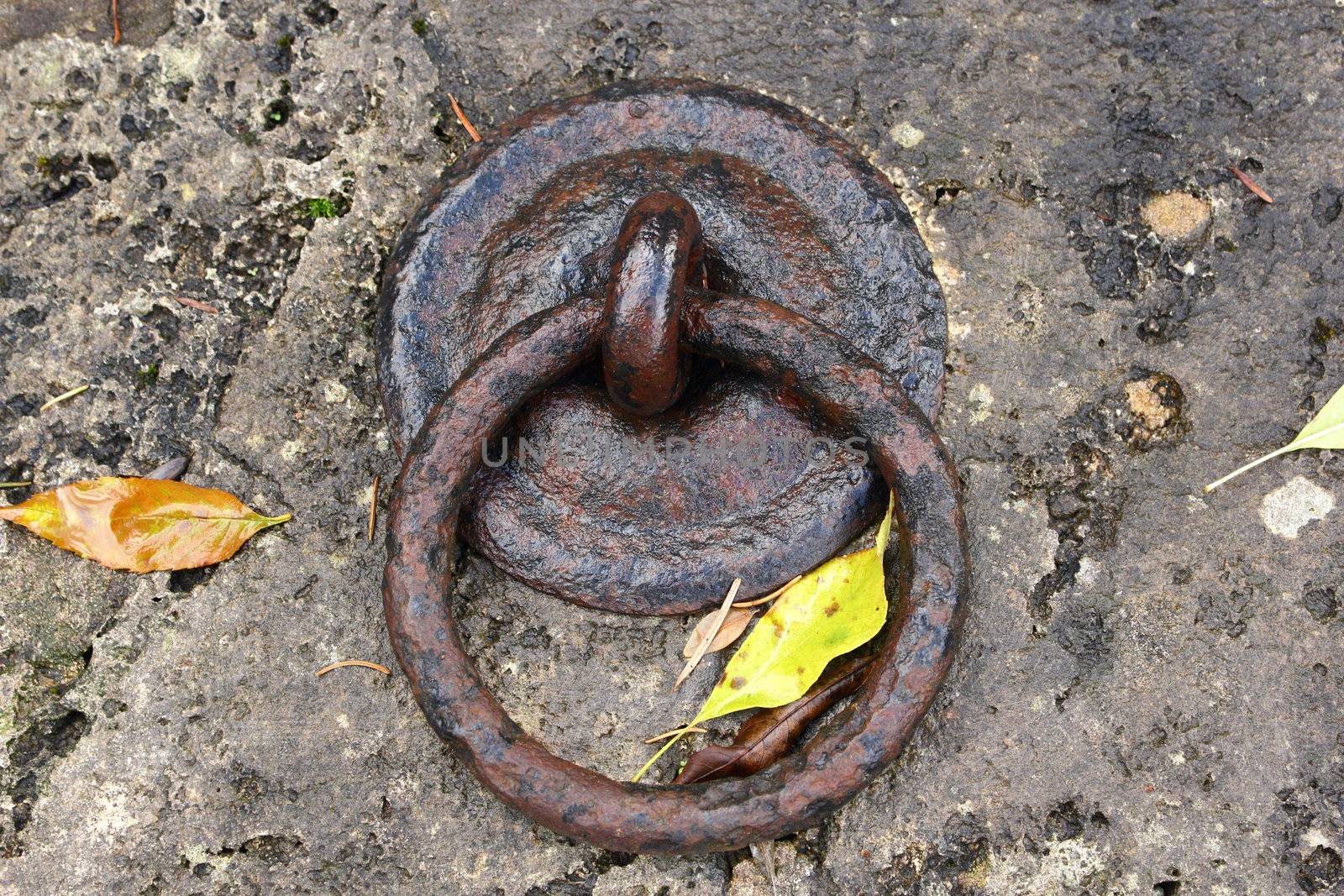 rusty old metal ring on a big stone wall