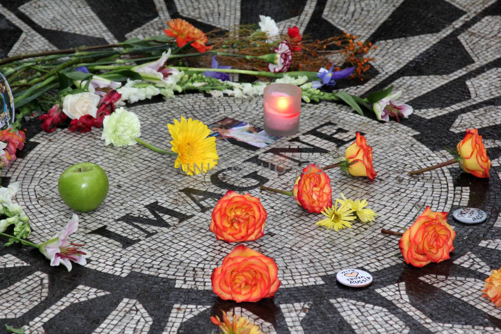 NEW YORK, USA - 9 OCTOBER: Admirers recollect John Lennon in his 72-nd birthday in Central Park, Strawberry Fields 9 october 2012, New York