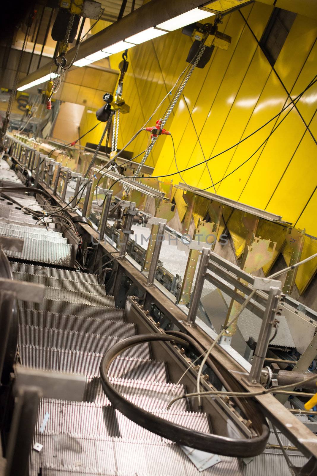 Installation of a new escalator during renovation works in a metropolitan railway station using heavy machinery