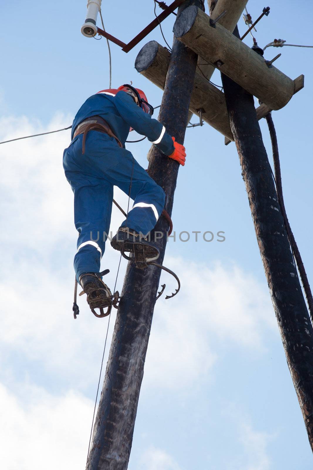 Electrician working at height by AleksandrN