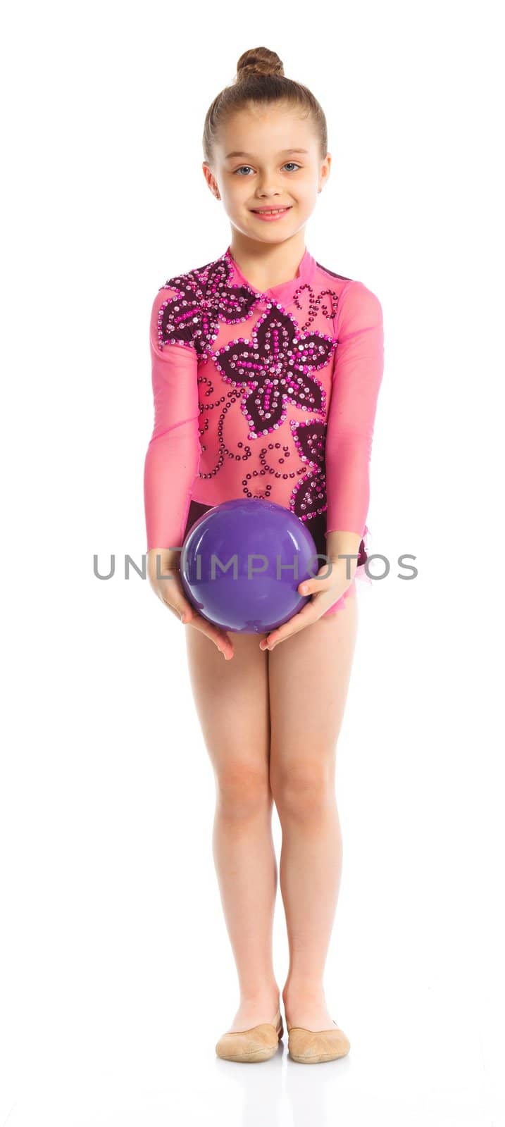 Little gymnast with ball on a white background. Sporting exercise, stretch, flexibility, aerobics