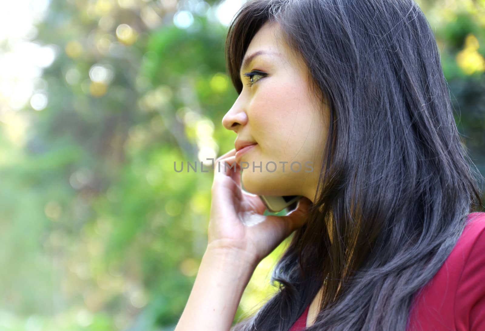 pretty woman making a phone call in the garden