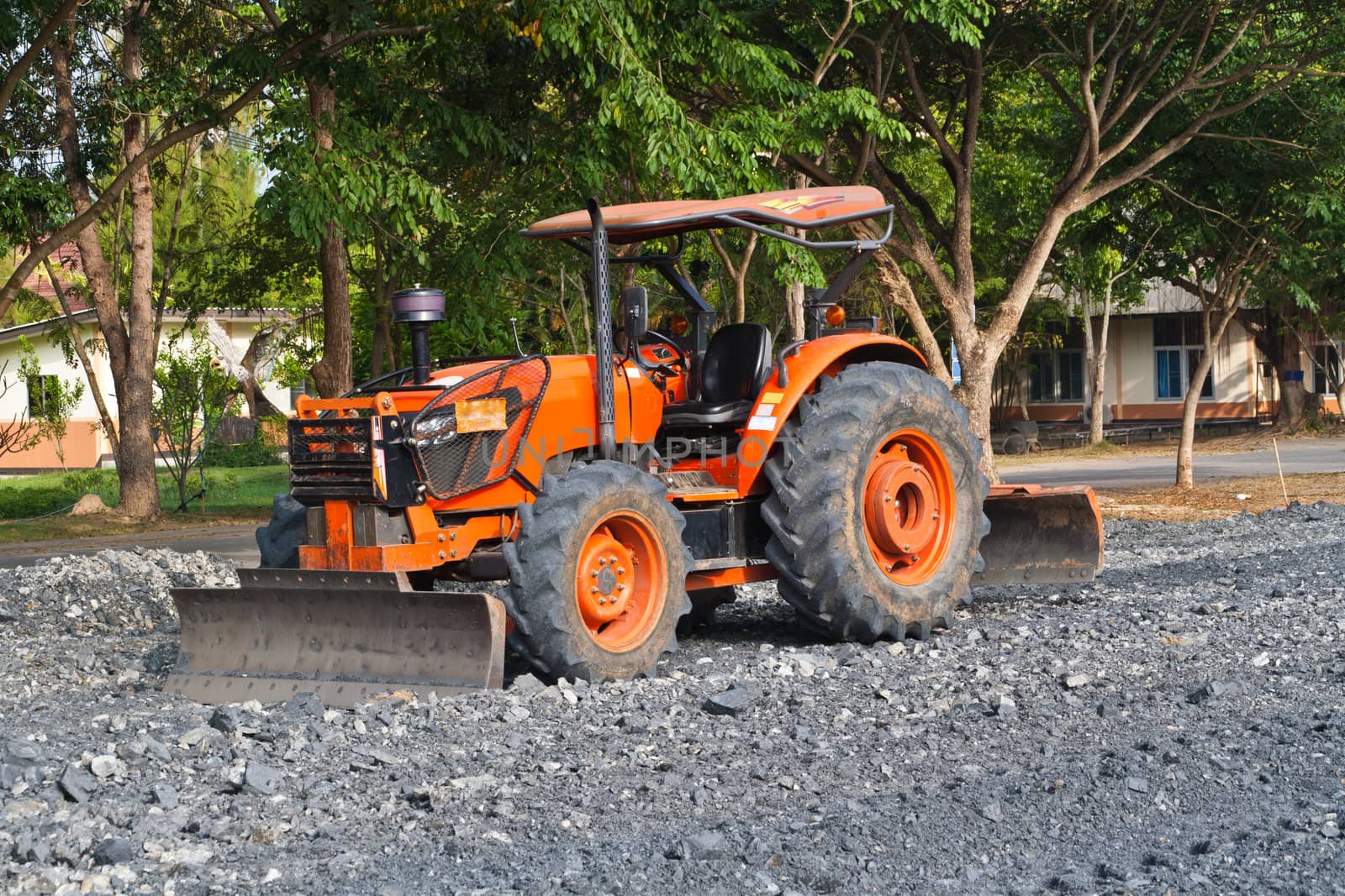 The tractor gravel Rouge in Football field.
