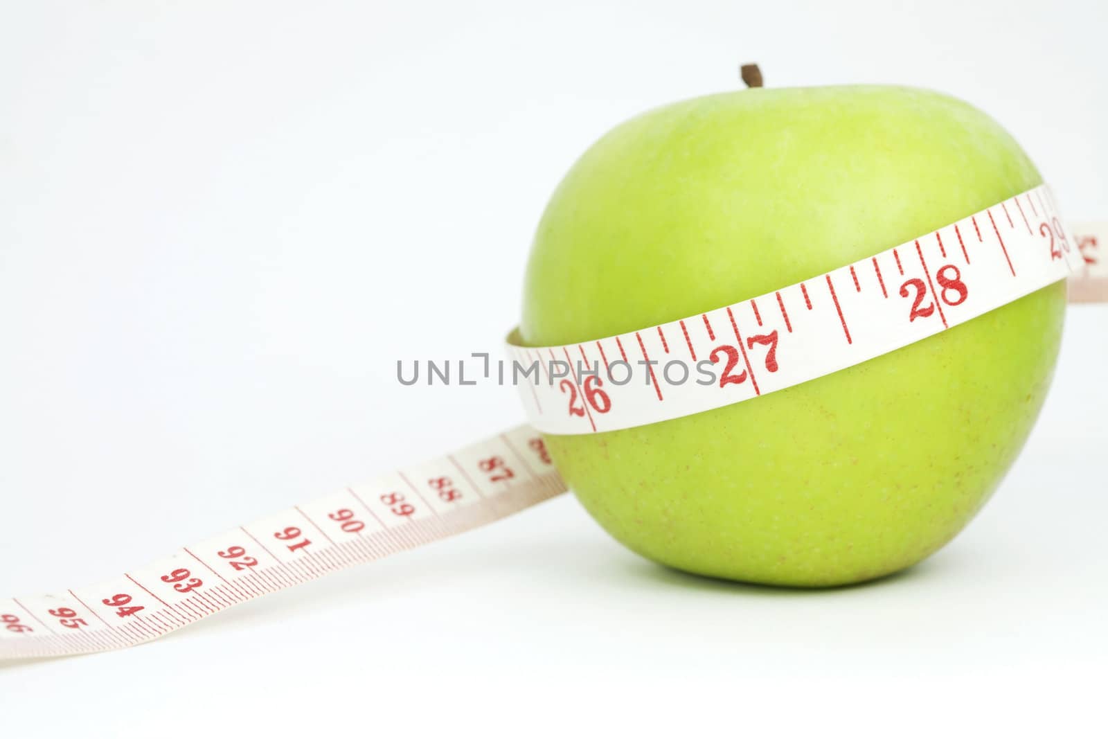 Fresh apple with measuring tape
