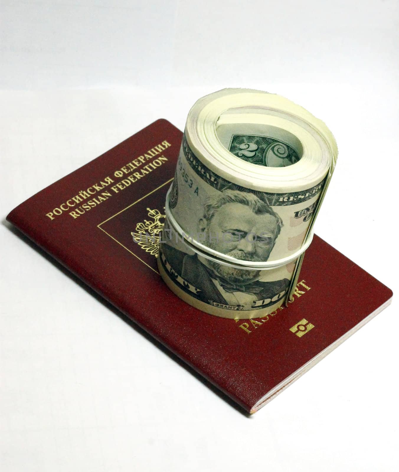 Stack of paper usa dollars and red passport under