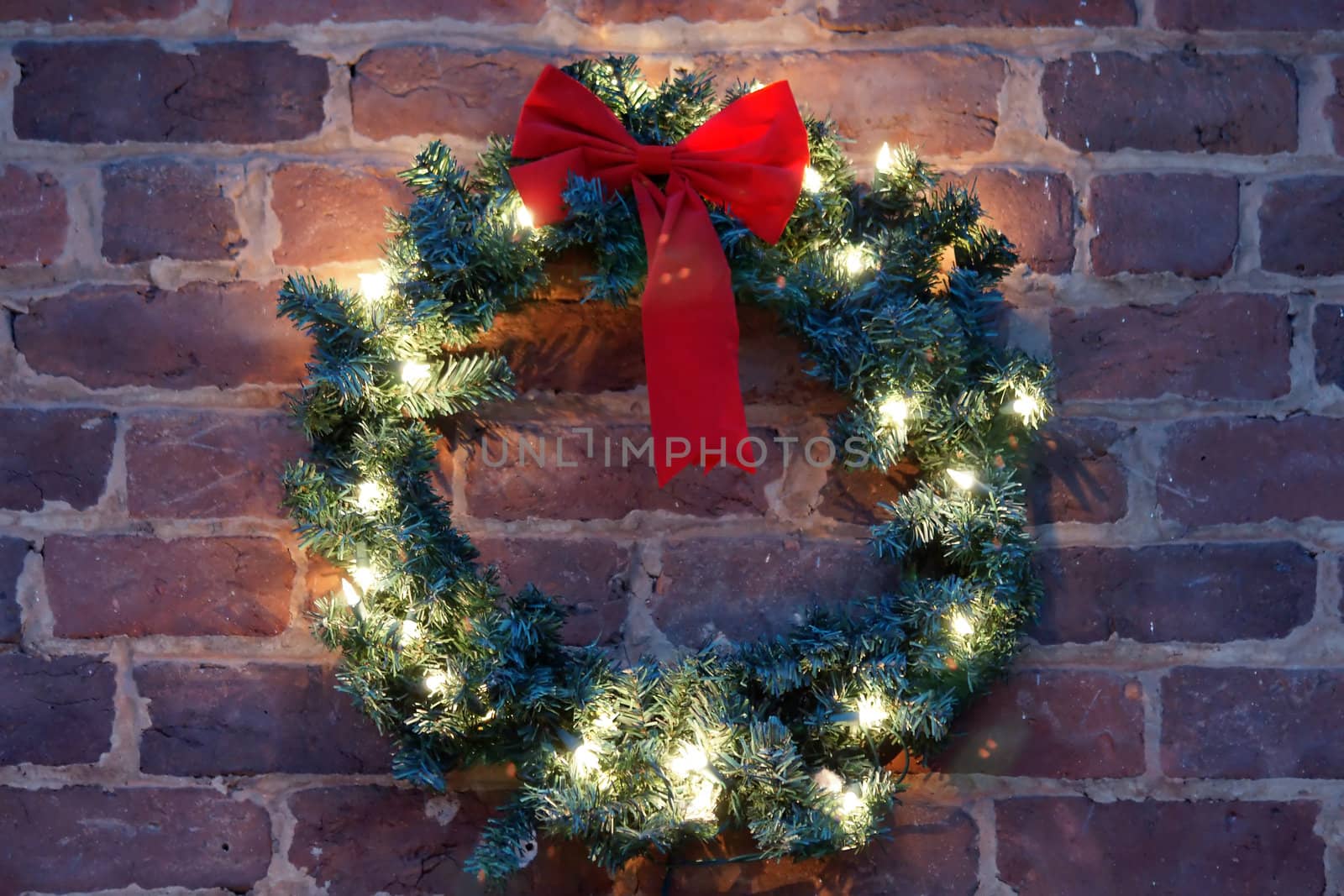 christmas wreath on brick wall