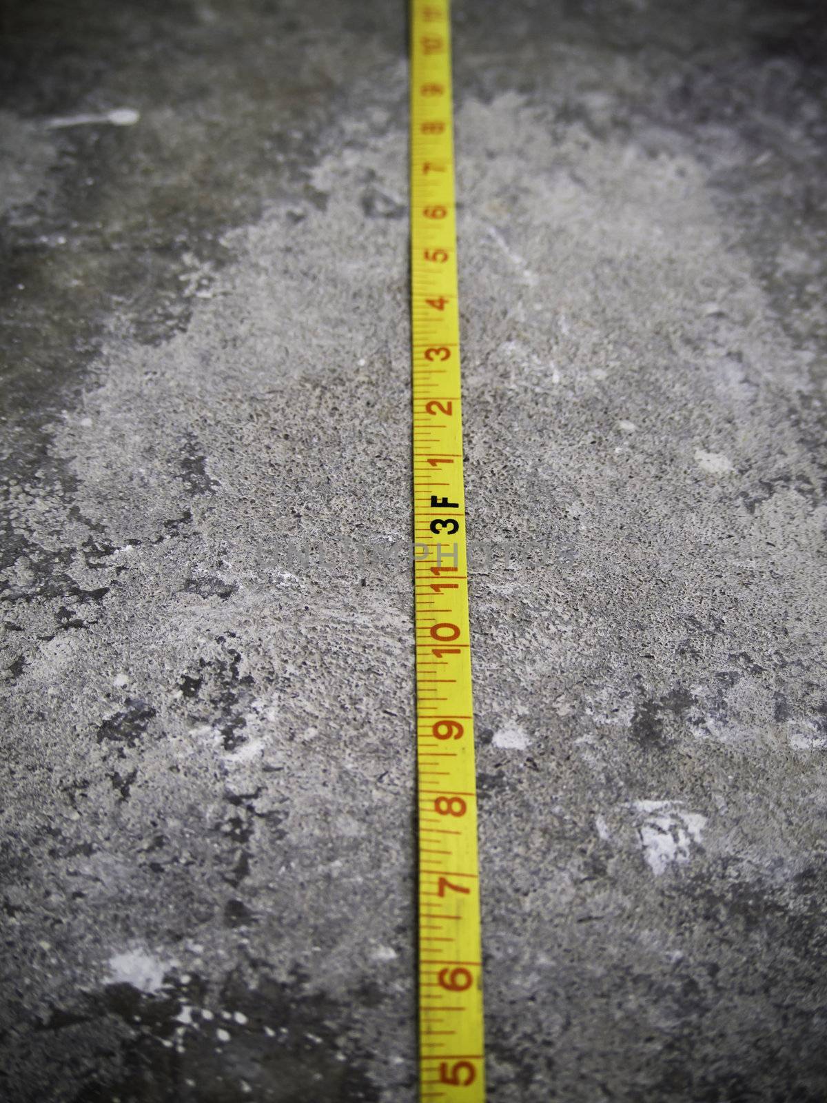 Construction Measuring Tape on Concrete Background 