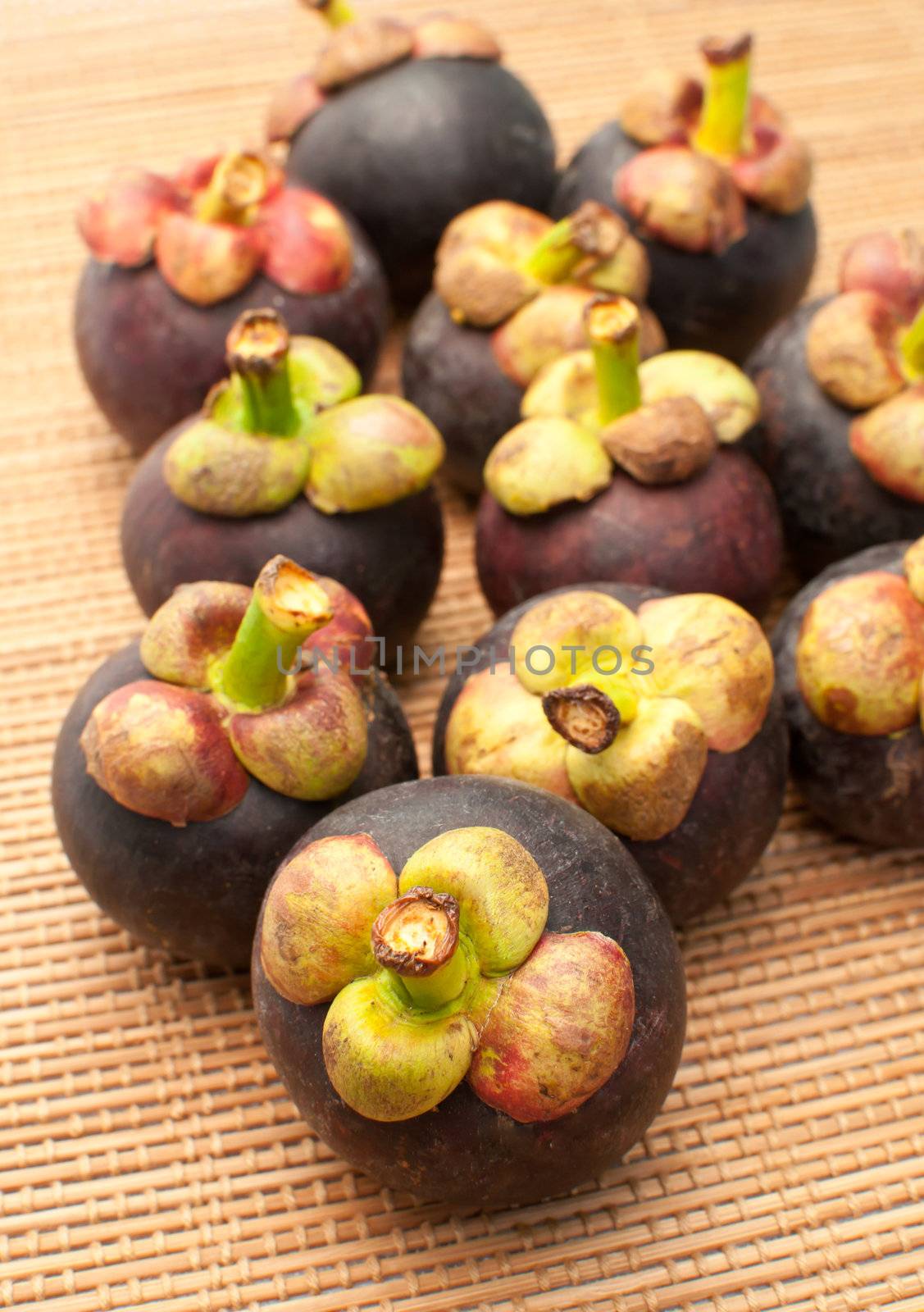 mangosteen on bamboo mat background