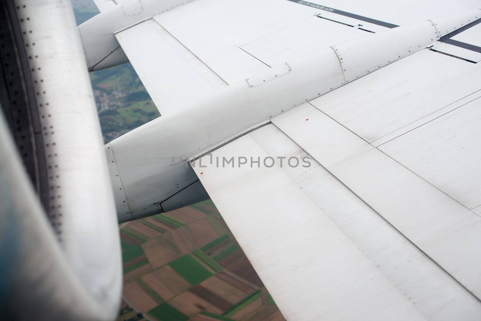 airplane wing, turbine, landscape as seen through the cabin window