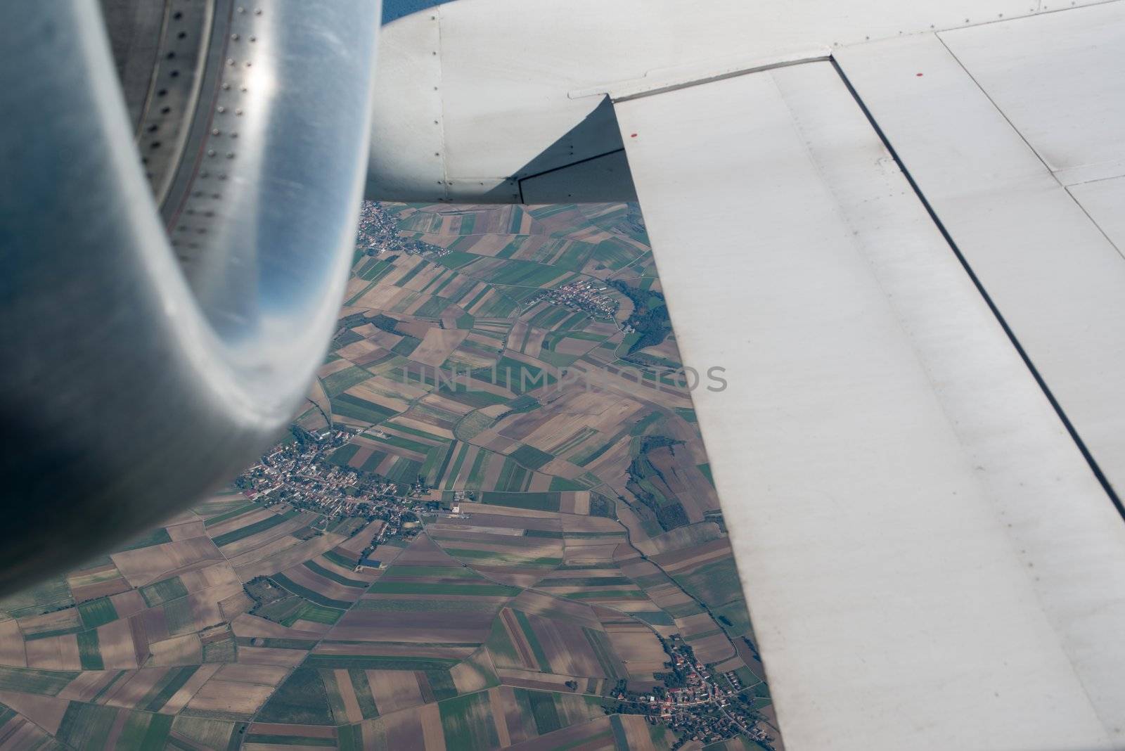 airplane wing, turbine, landscape as seen through the cabin window