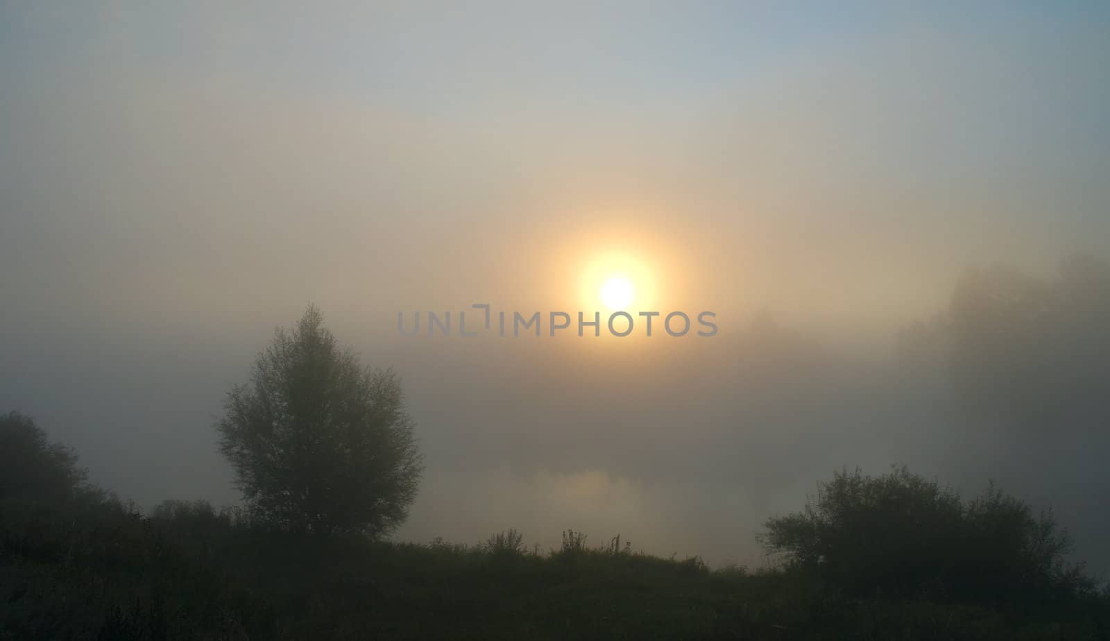 Beautiful morning fog on the river. Autumn landscape.