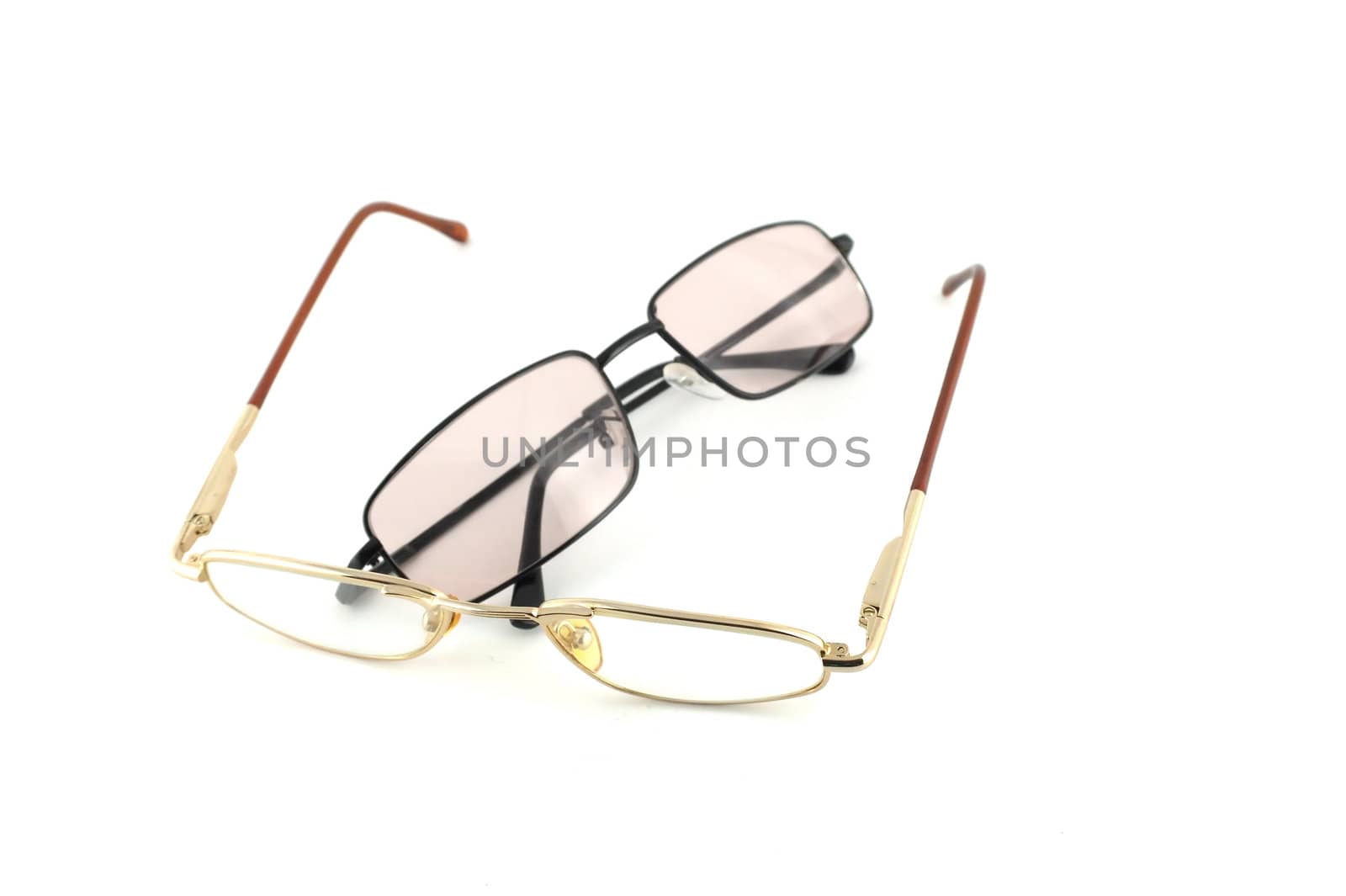Two optical glasses over white
