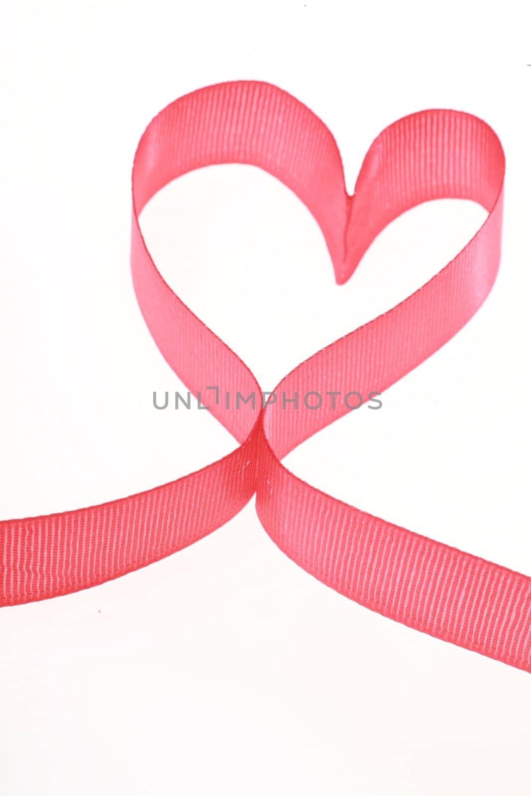 a ribbon forms a heart on a white background