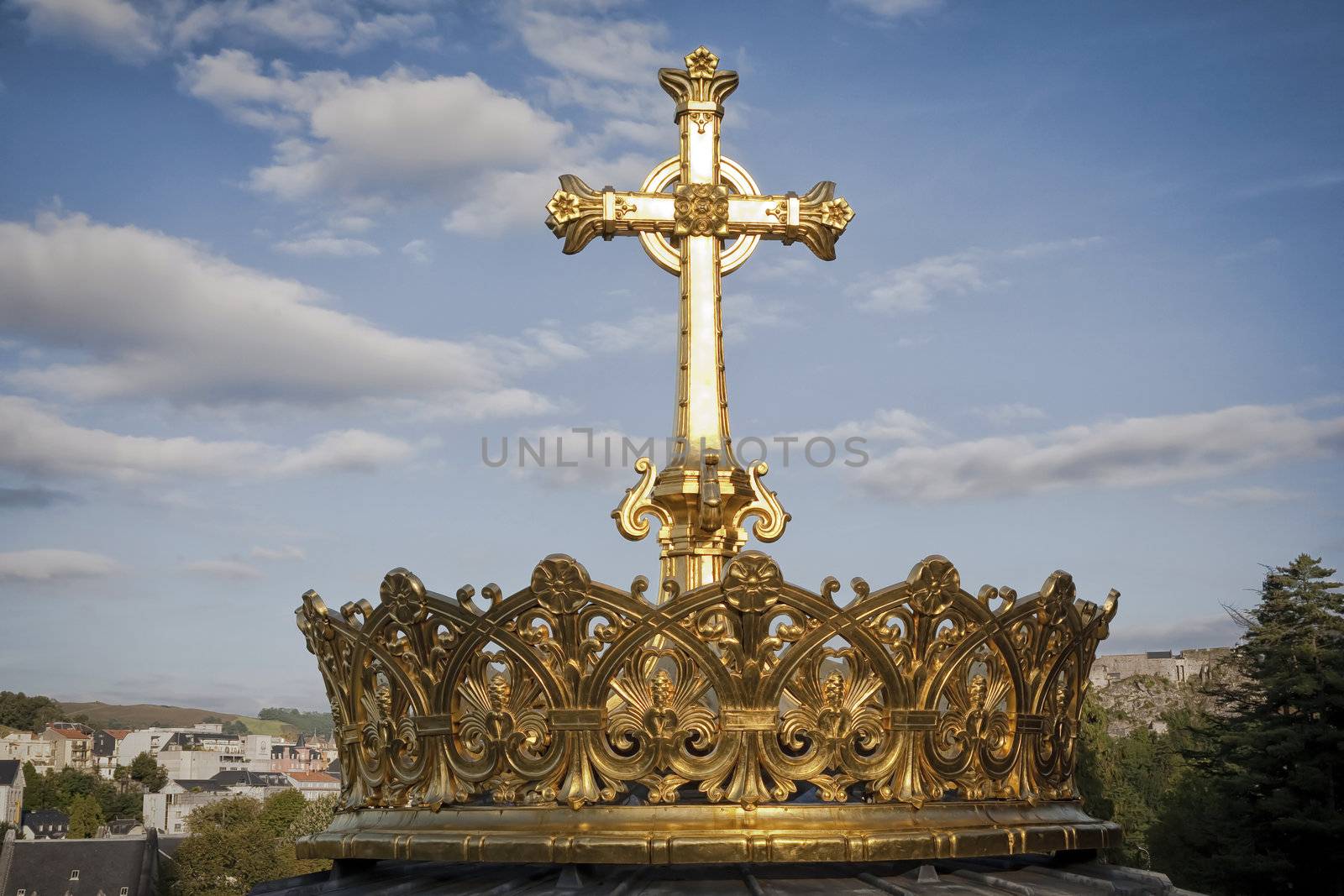 Gilded crown and cross of the dome of the Basilica of Our Lady of the Rosary of Lourdes, France. The crown symbolises the power and glory of God and is donated by Irish pilgrims many years ago.
