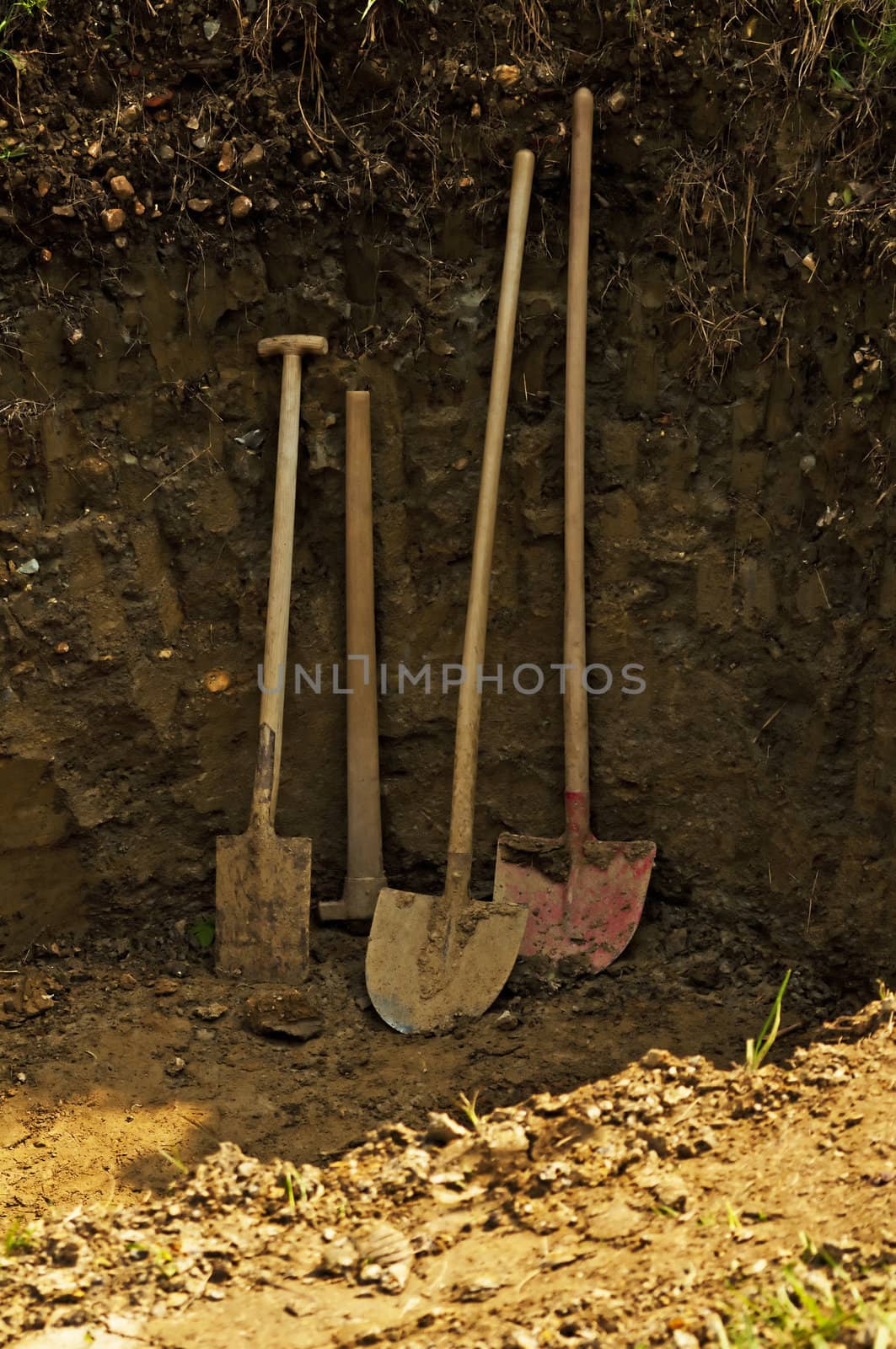 hole with shovel,spade and hoe