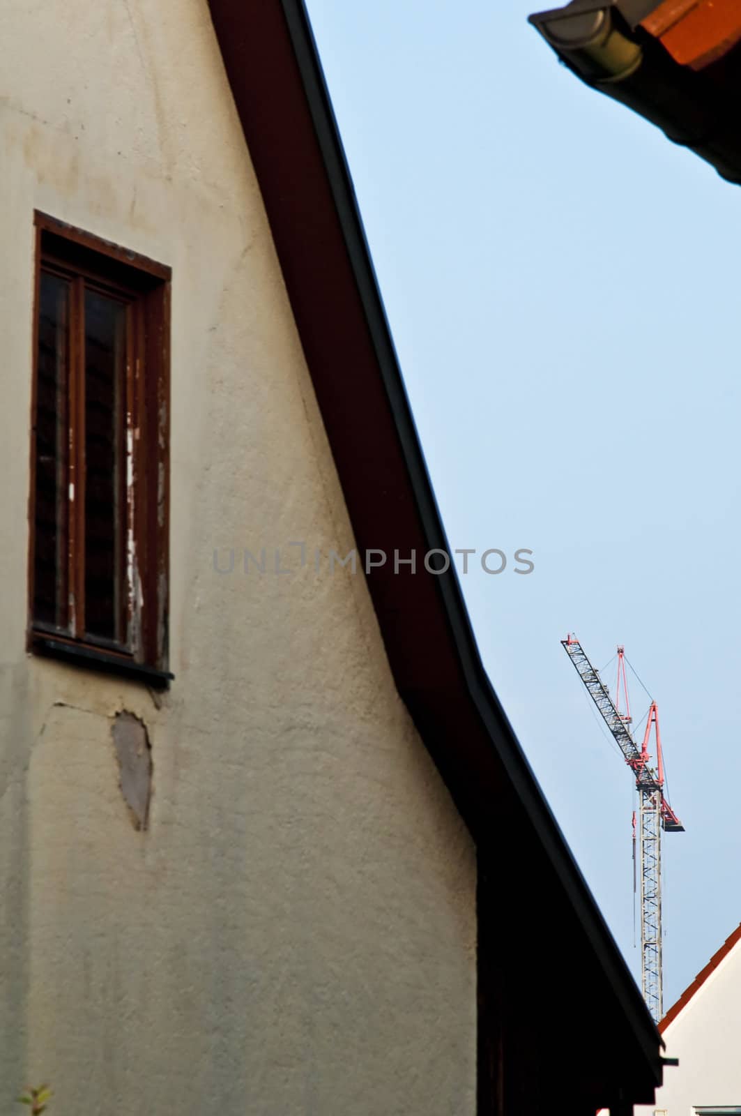 building crane with old house