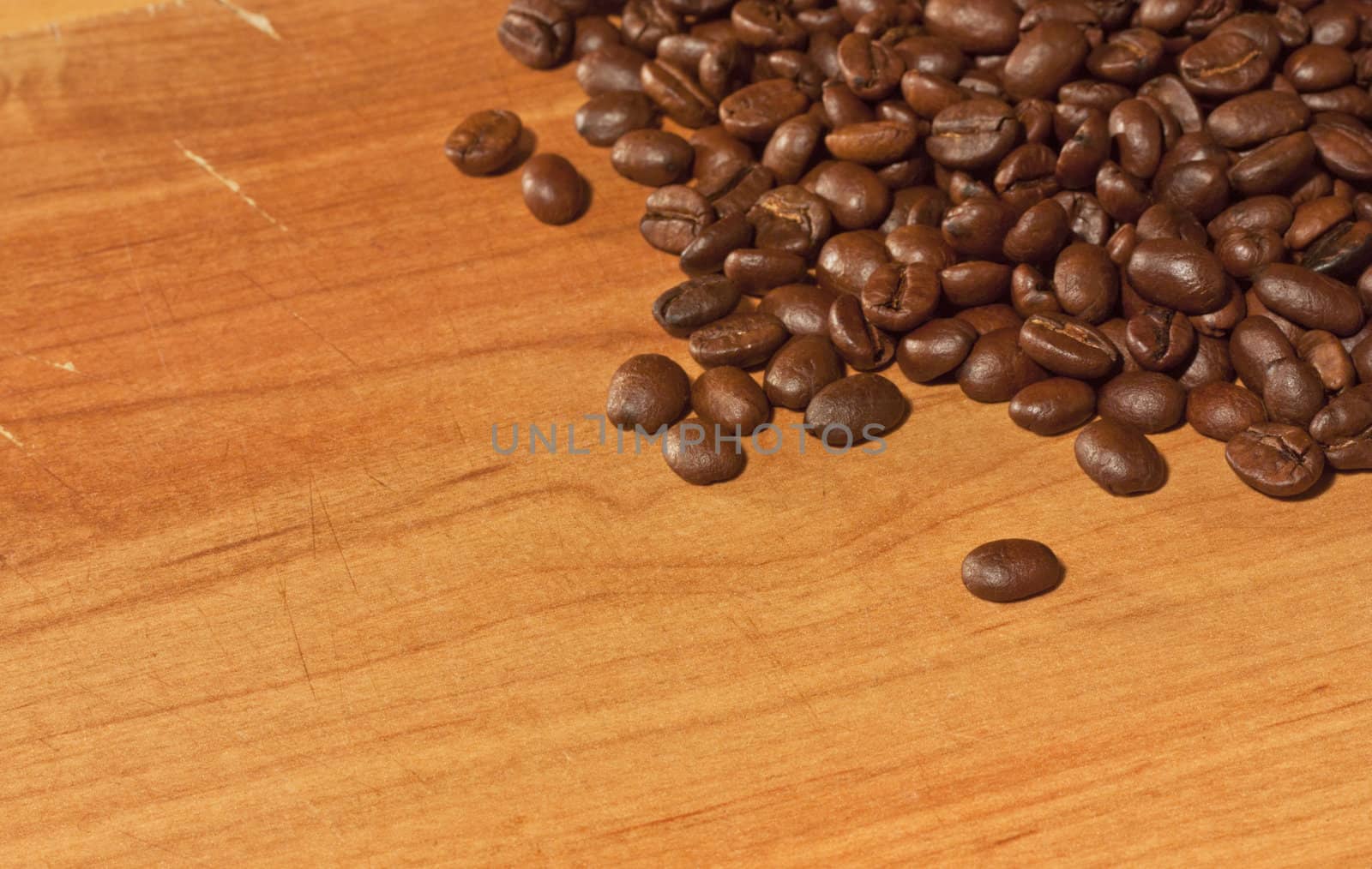 Coffee beans on grunge wooden background by alexvav