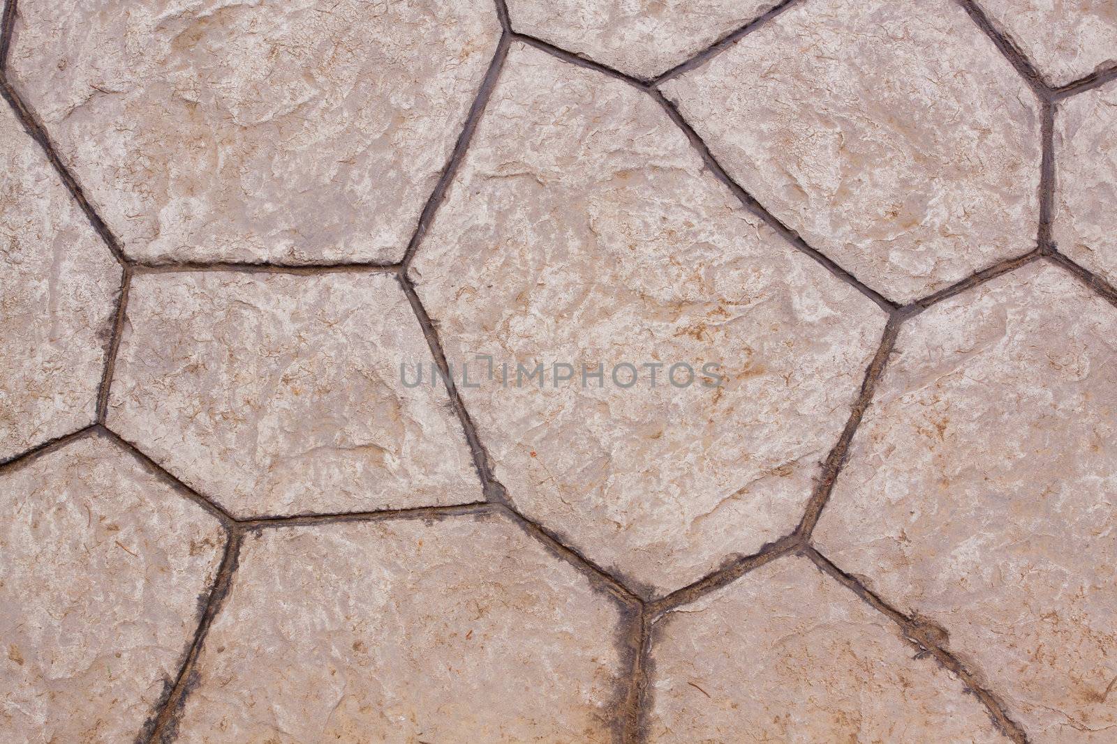 An abstract of a stone tile pation with lines and shapes that are original creating a background texture image of the grey natural material.