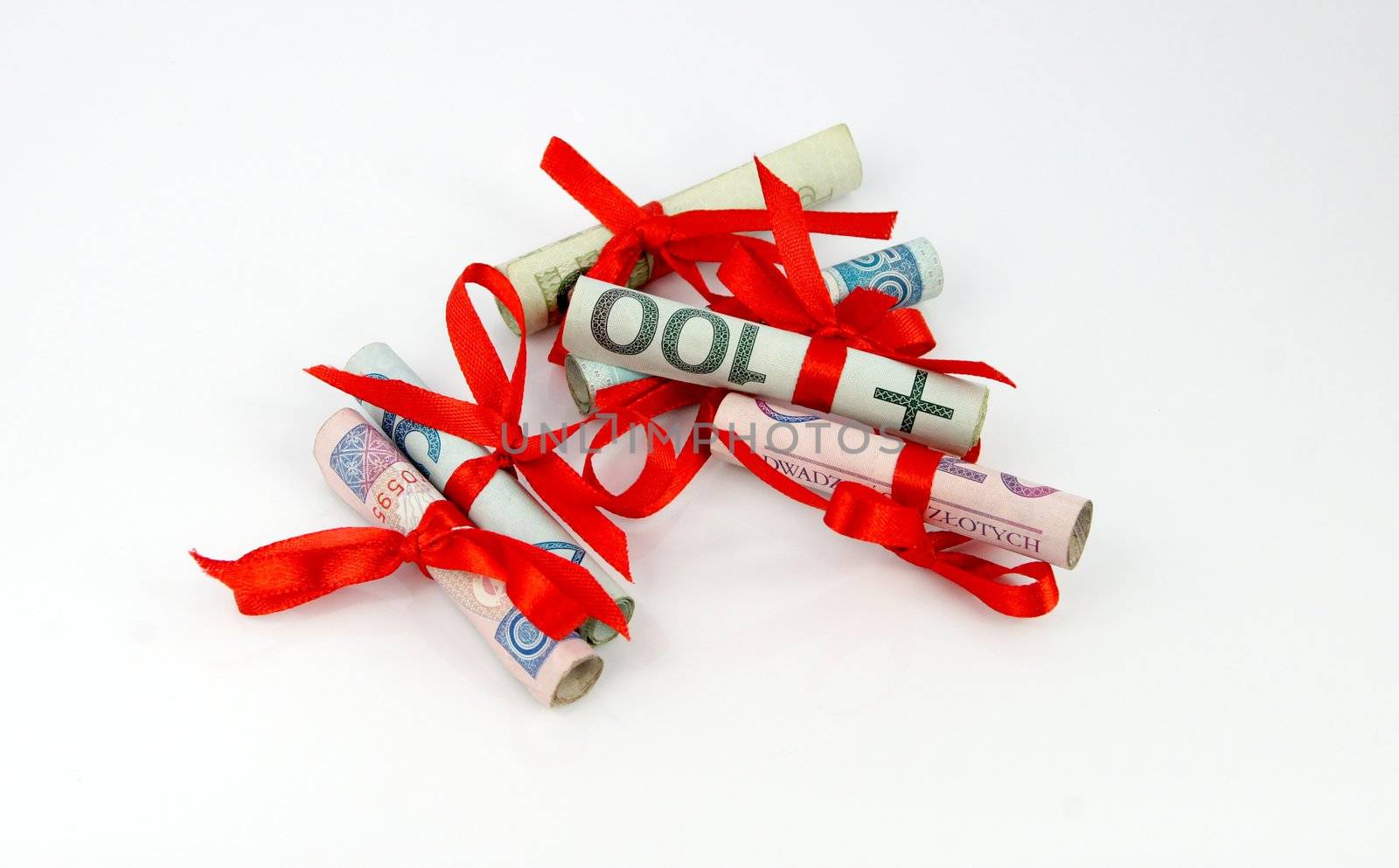 Roll of money and bow isolated on white