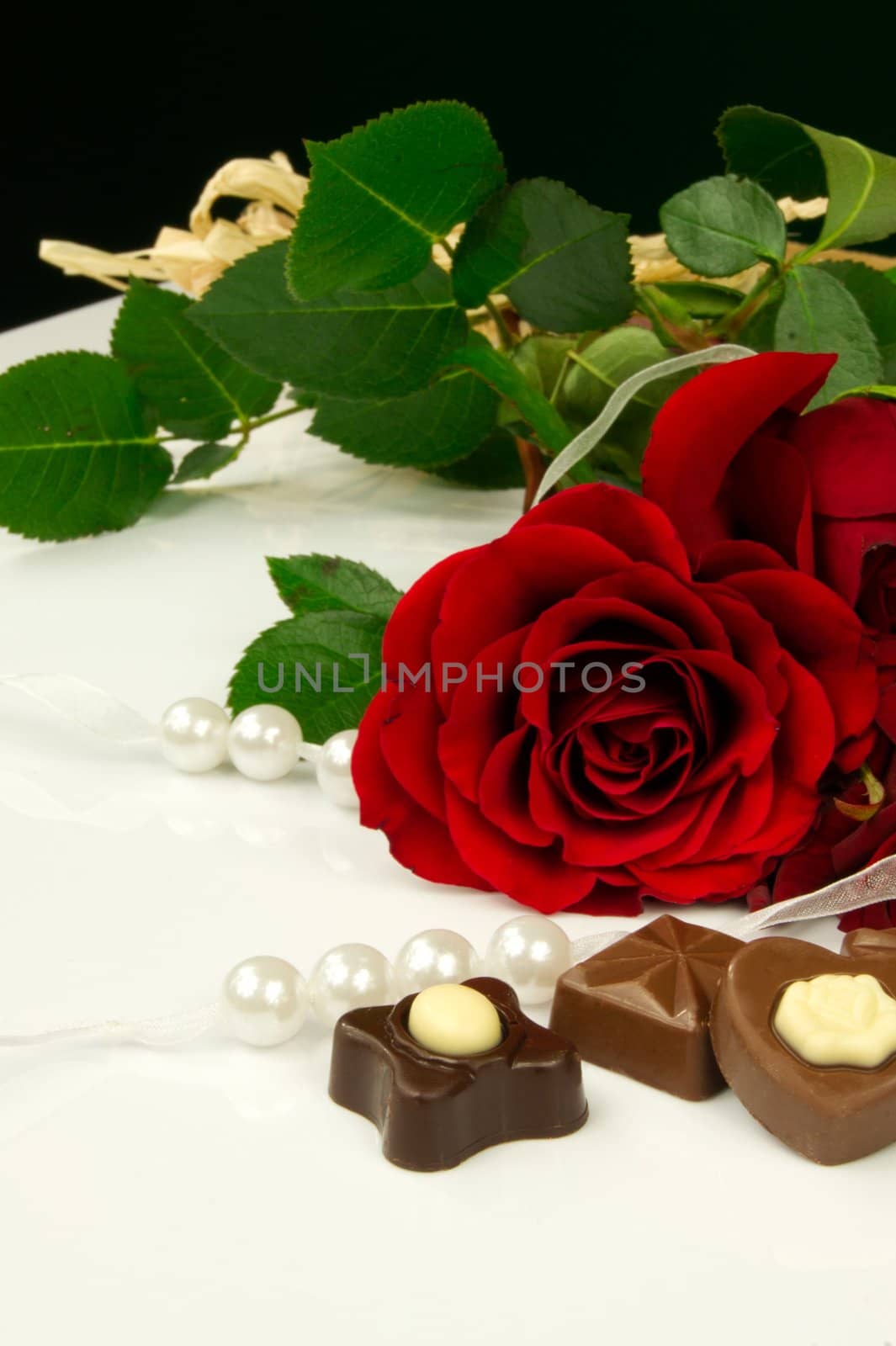 Rose, pearls and chocolate. Traditional beauty valentine composition