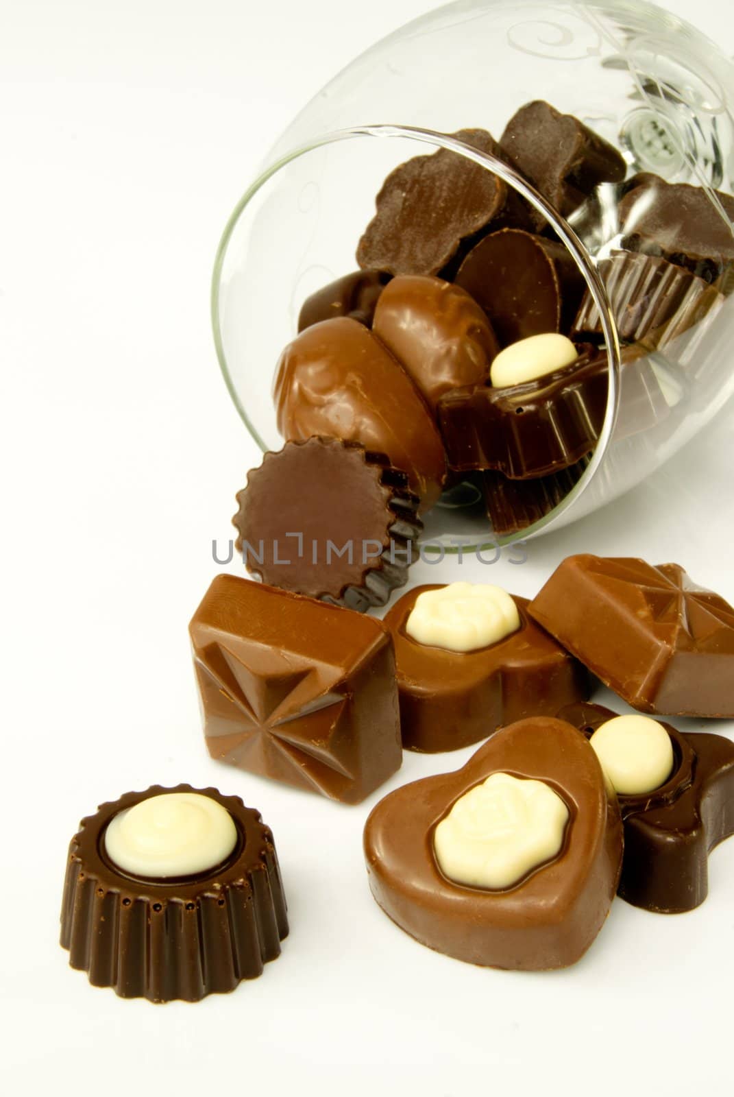 Closeup of valentine chocolates in overturned glass