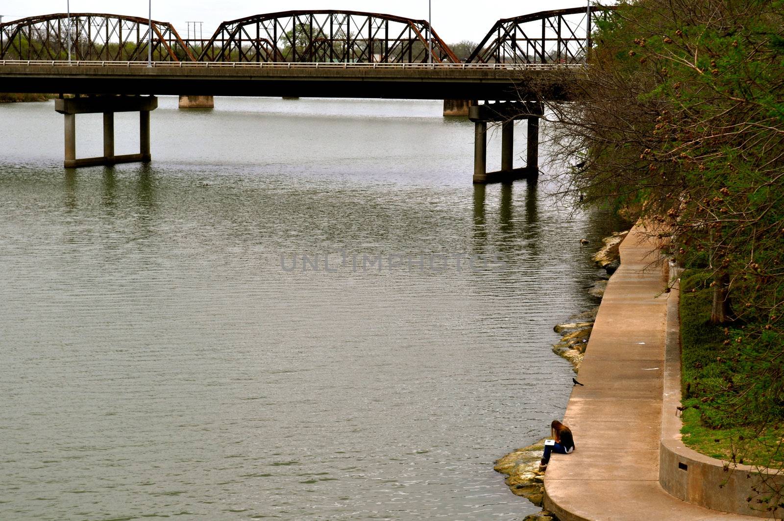 Waco woman reads on bank of river