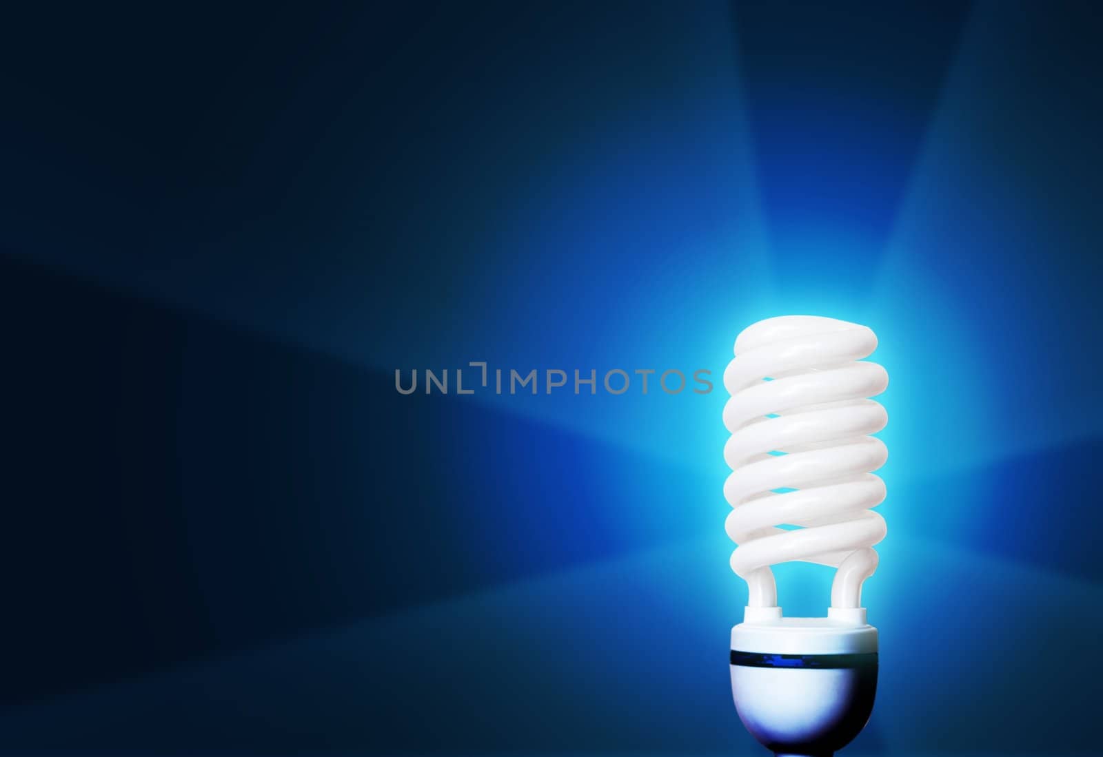 light bulb glowing on blue background 