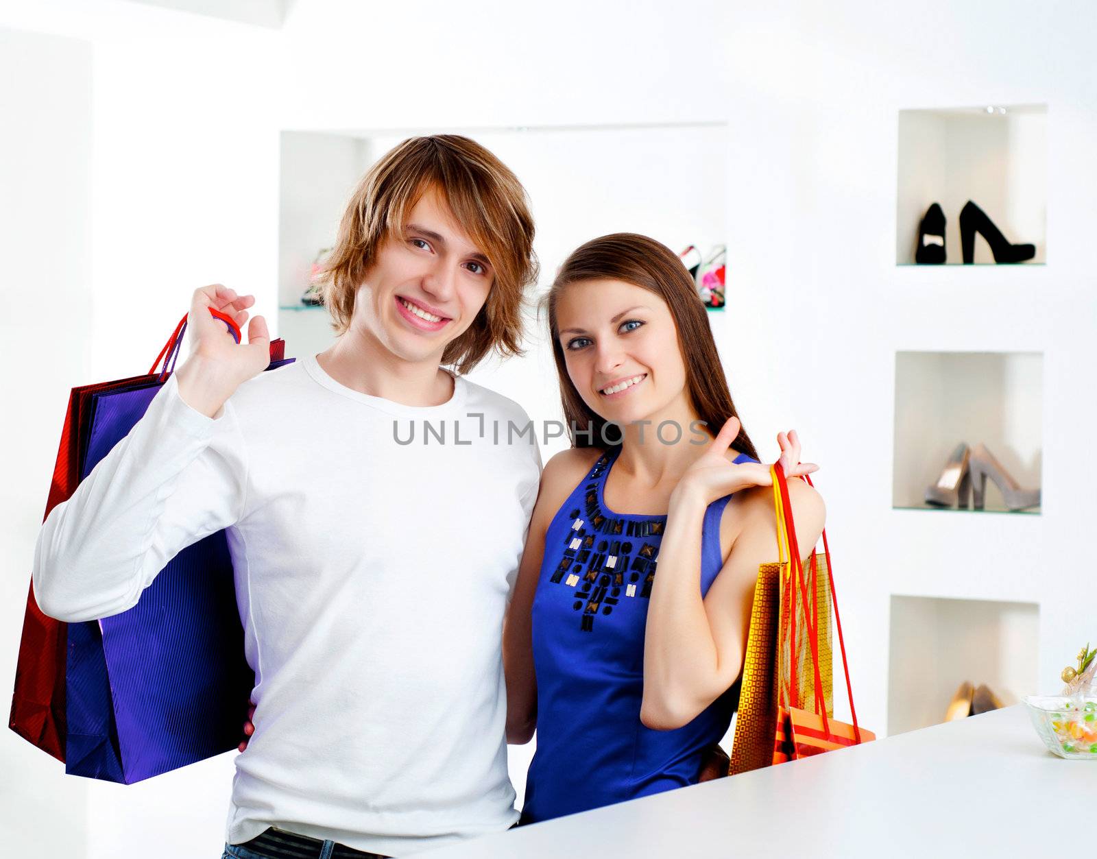 cute man and the woman in shop choose clothes