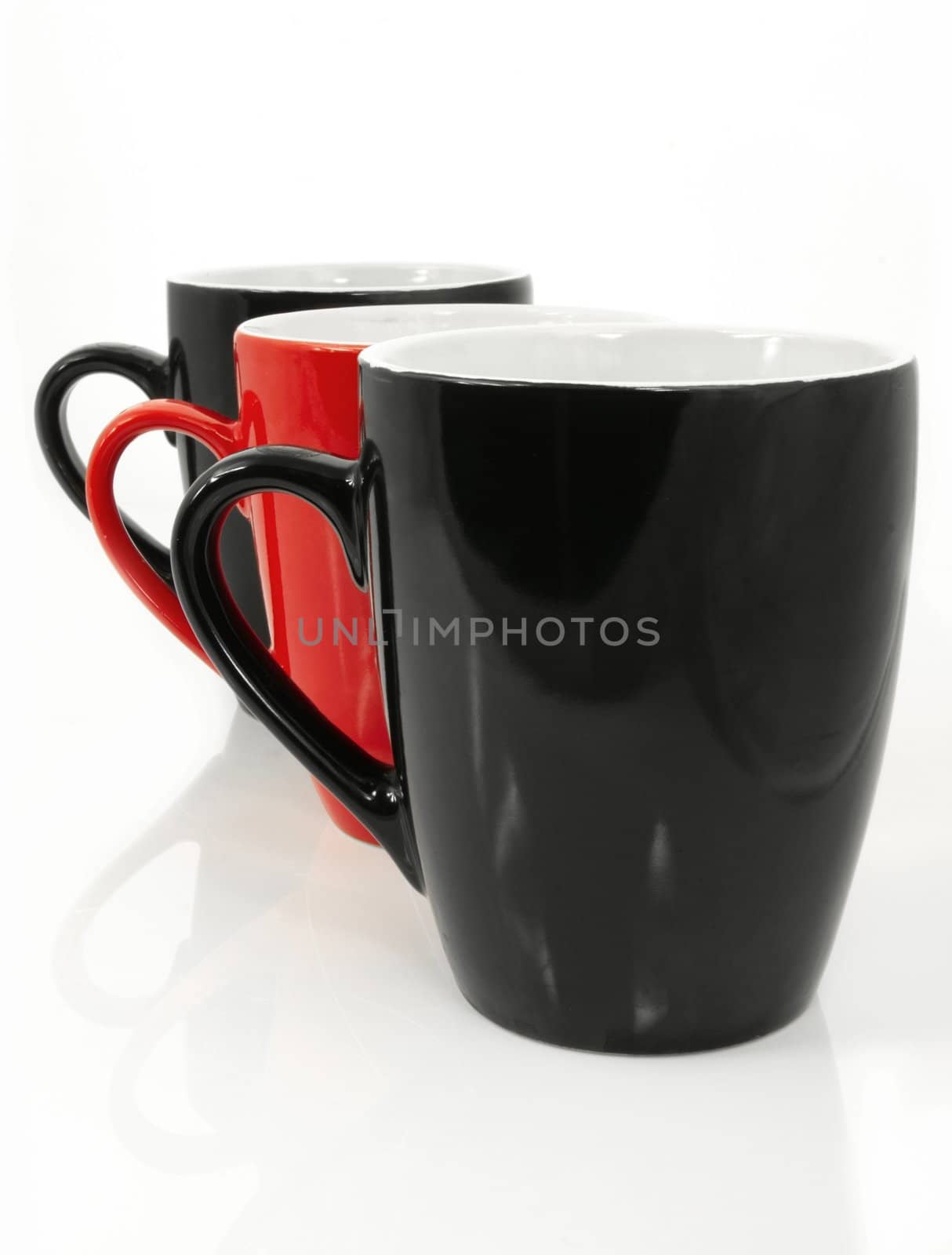 Three coffee cups. Red cup in the center