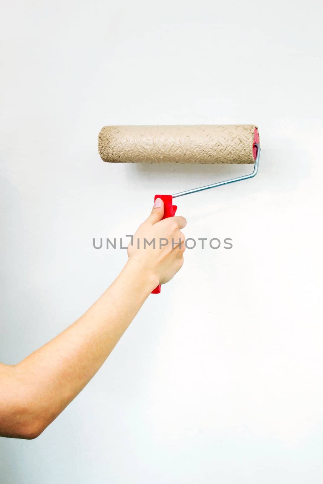 Roller with paint on white wall by simpson33