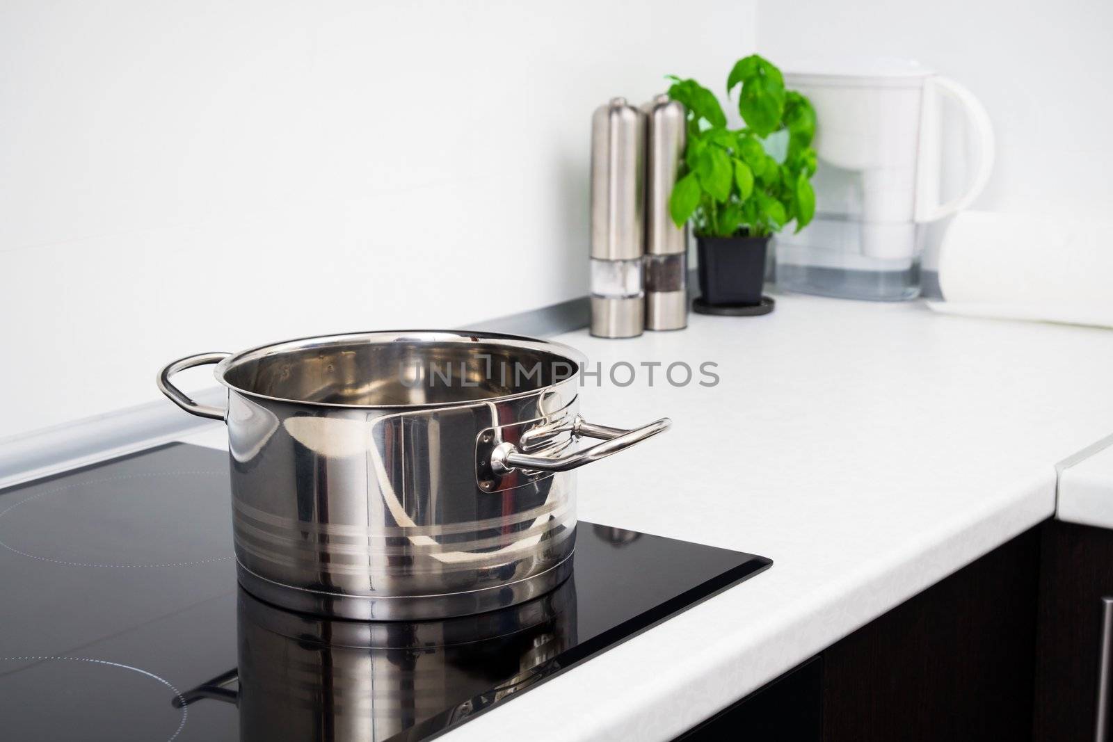Pot in modern kitchen with induction stove by simpson33