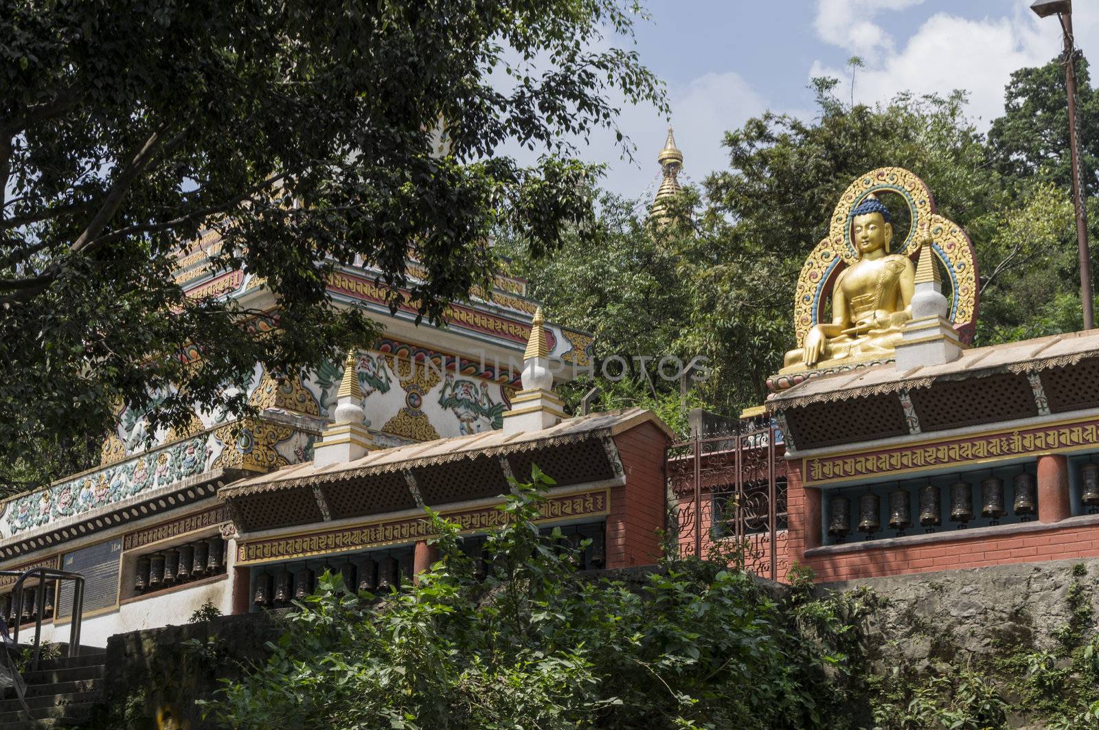 Buddhist temple in kathmandu, nepal with big sitting buddha on top