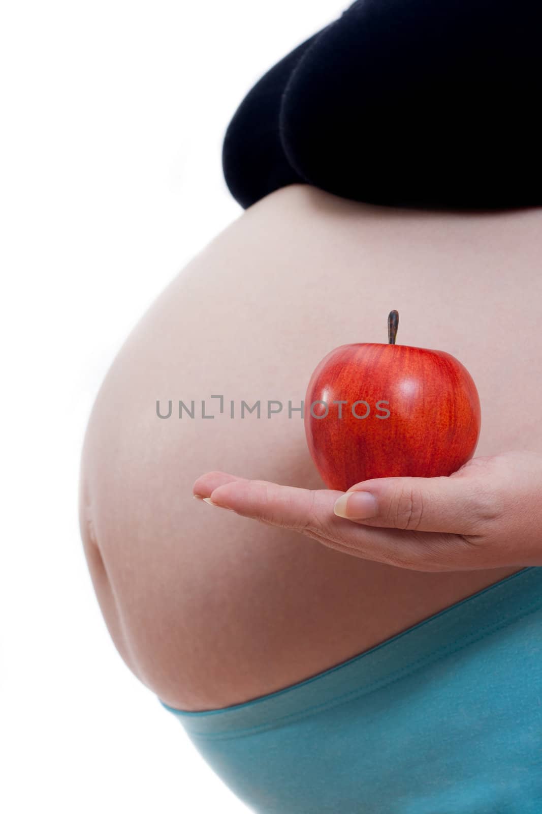 Pregnant woman with an apple in her hand on withe background, concept 