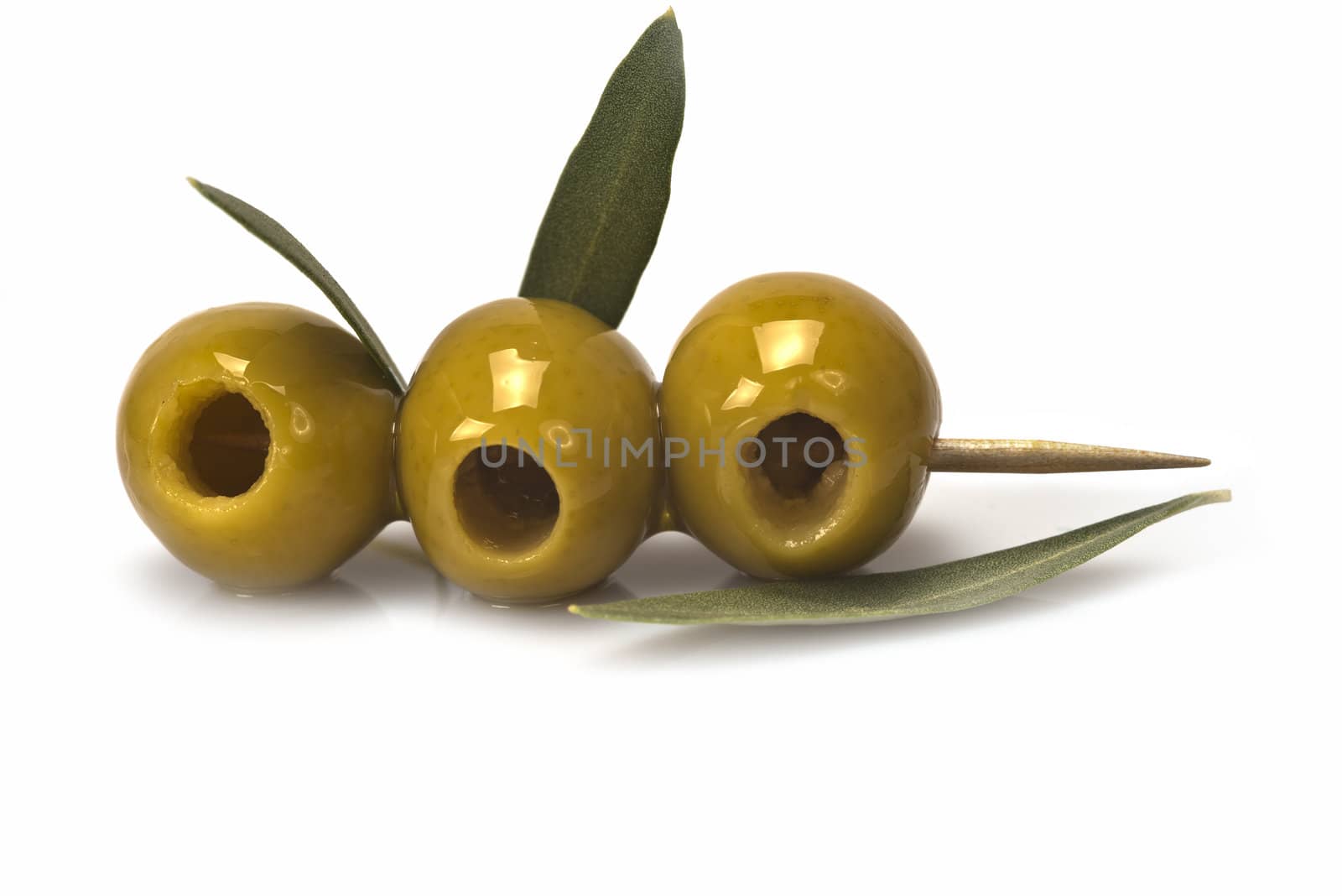 Three olives on a toothpick isolated on a white background