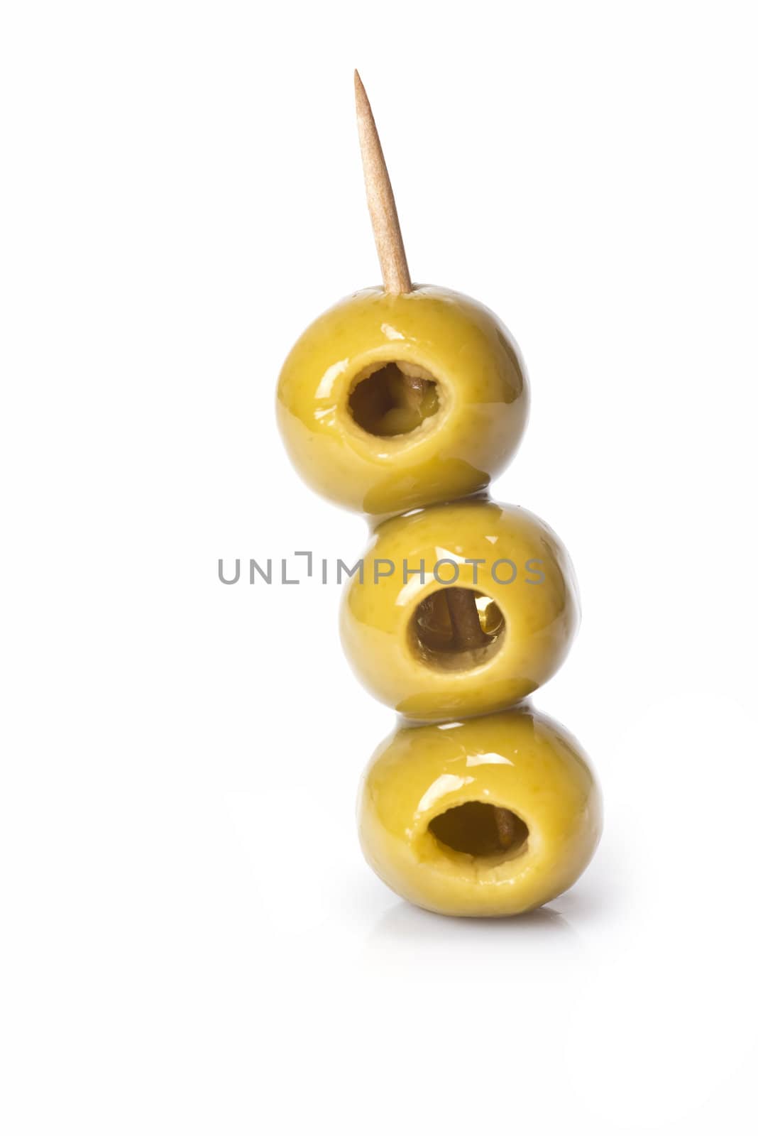 Three olives on a toothpick isolated on a white background