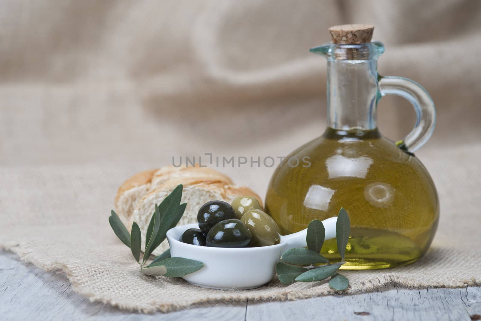 Olive oil with olives and bread by angelsimon