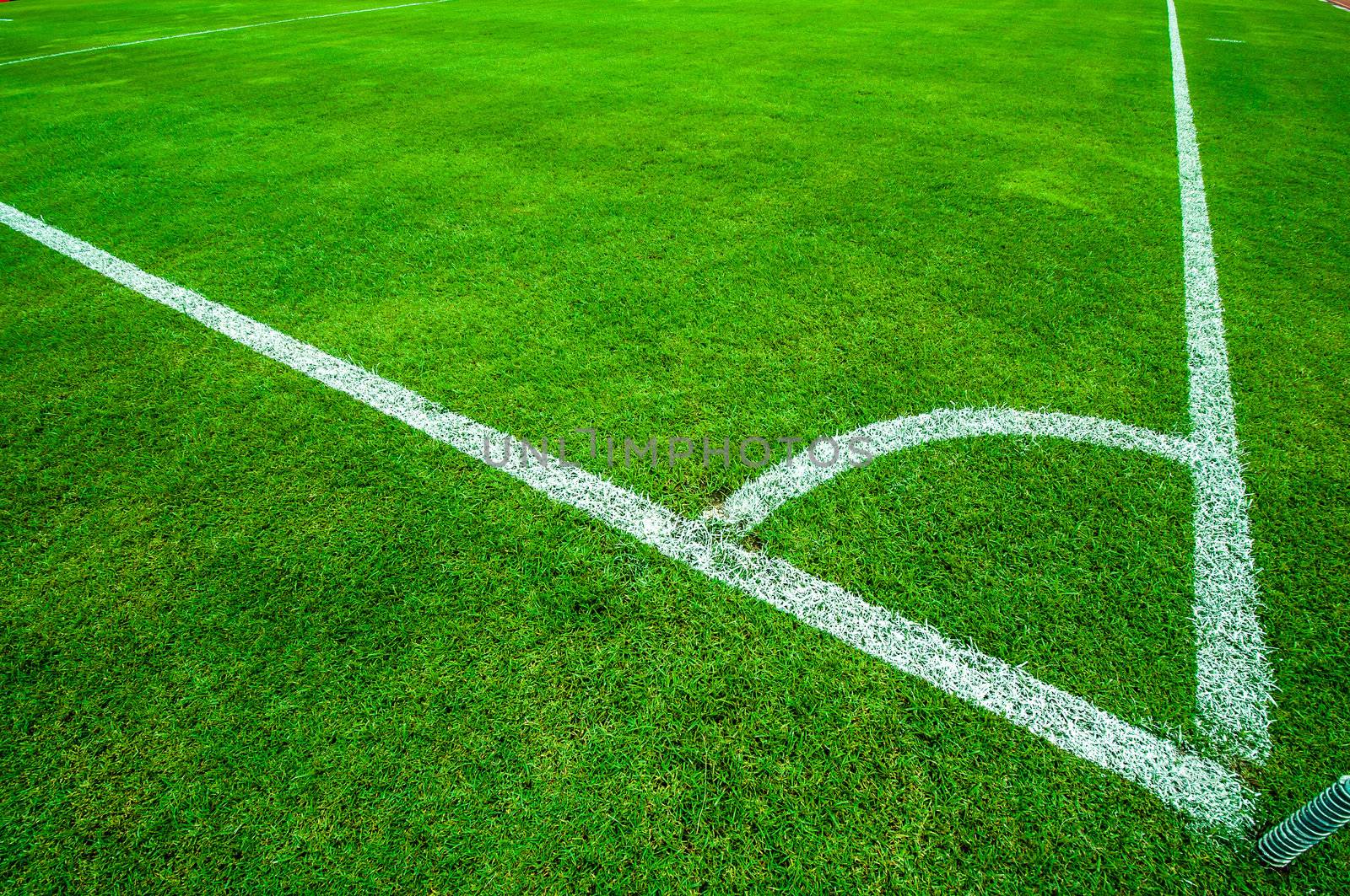 Football (soccer) field corner with white marks by TanawatPontchour