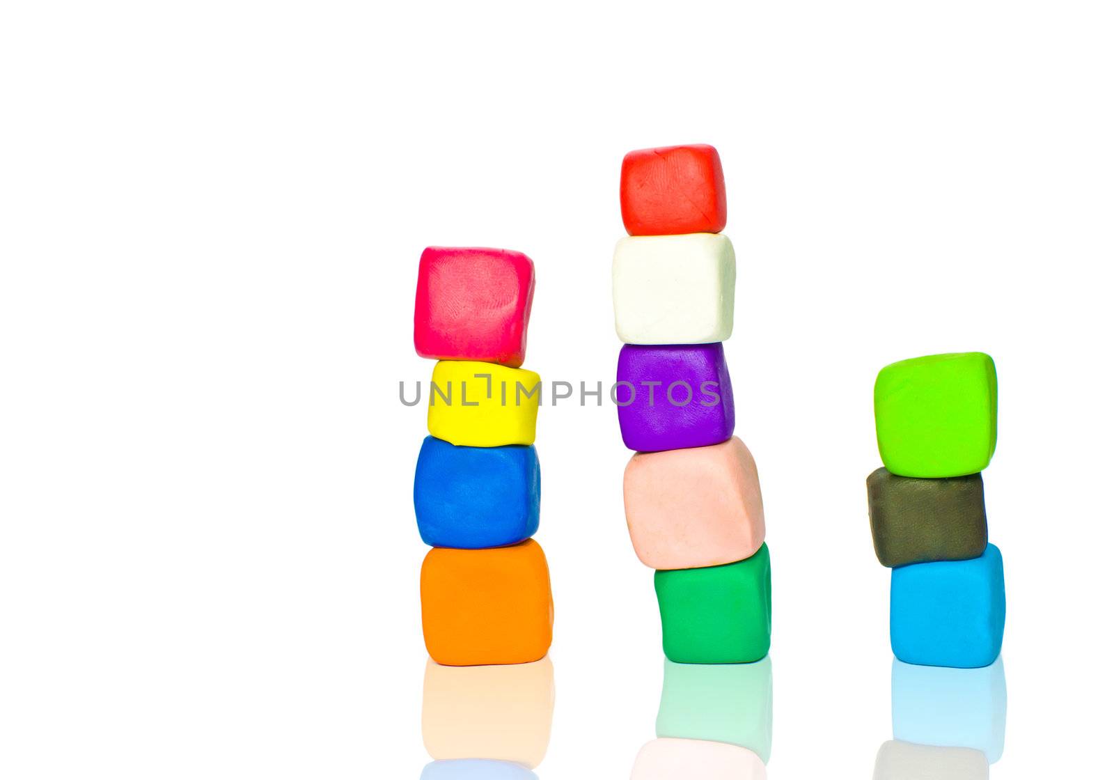 Stacks of colorful plasticine blocks isolated on white