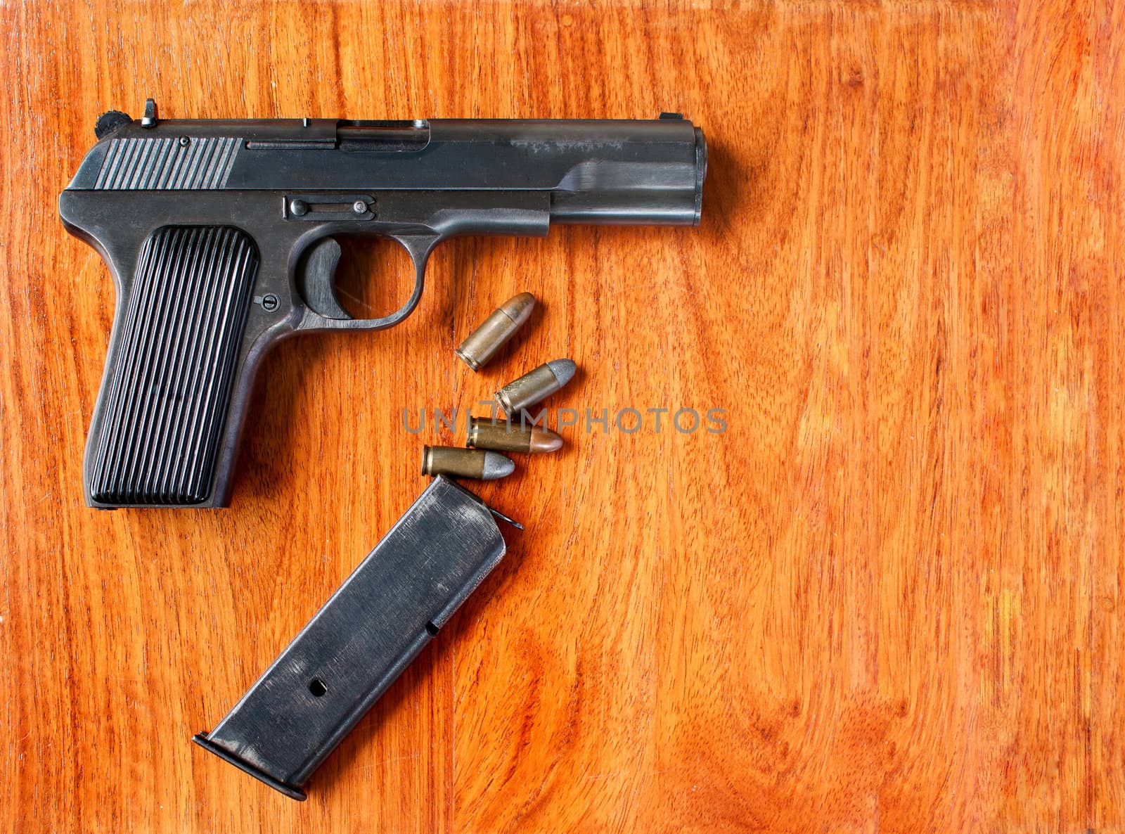 Gun and bullets on wood  table