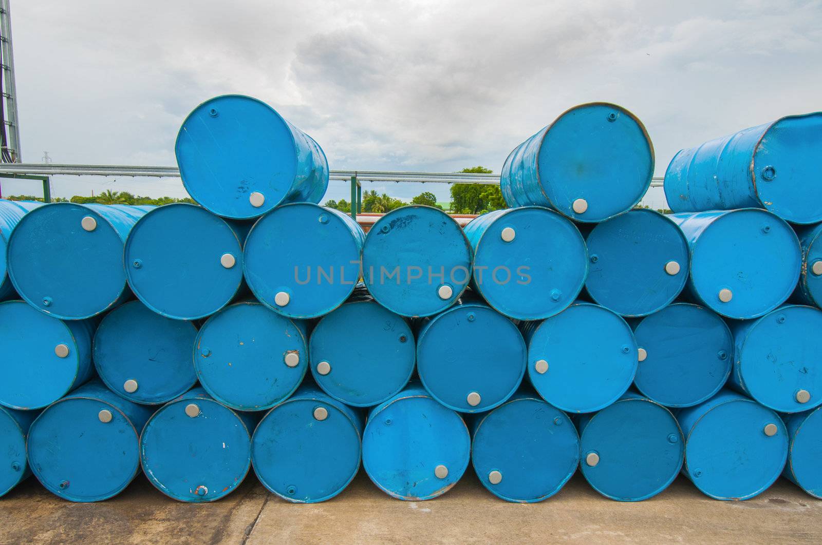 oil barrels or chemical drums stacked up by TanawatPontchour