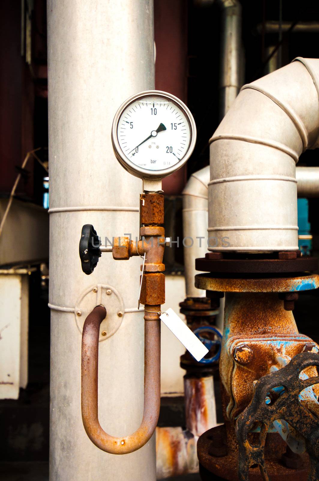 manometer, pipes and faucet valves of heating system in a boiler room by TanawatPontchour