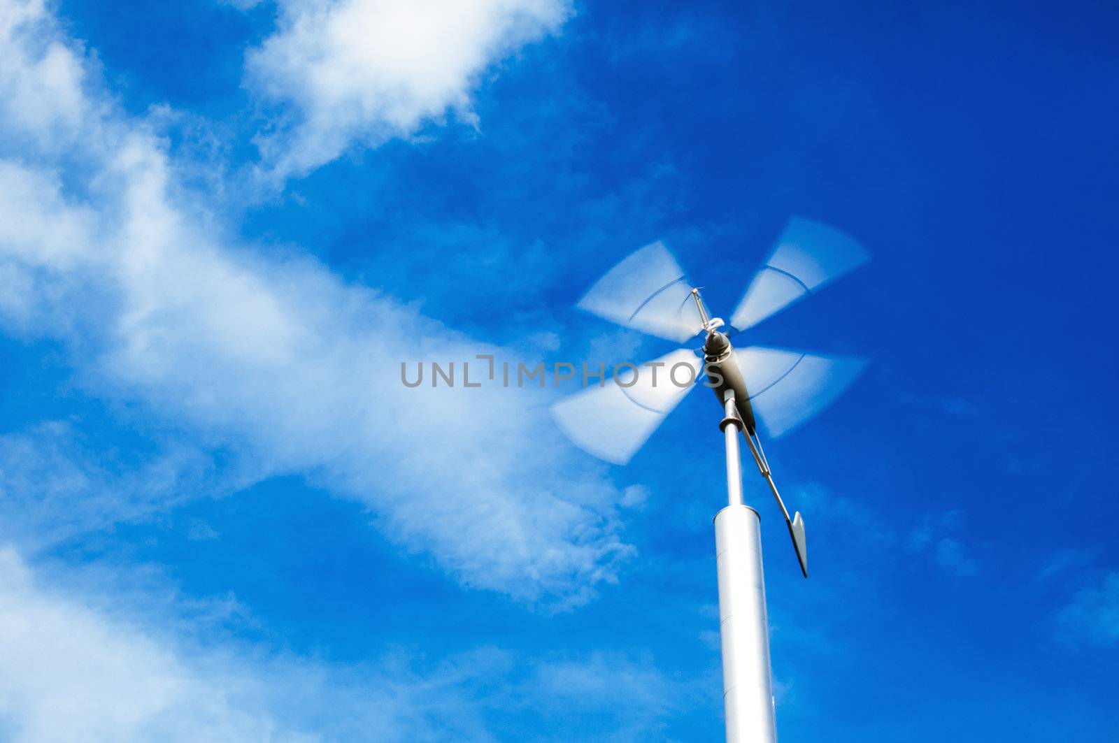 wind turbine on cloudy blue sky