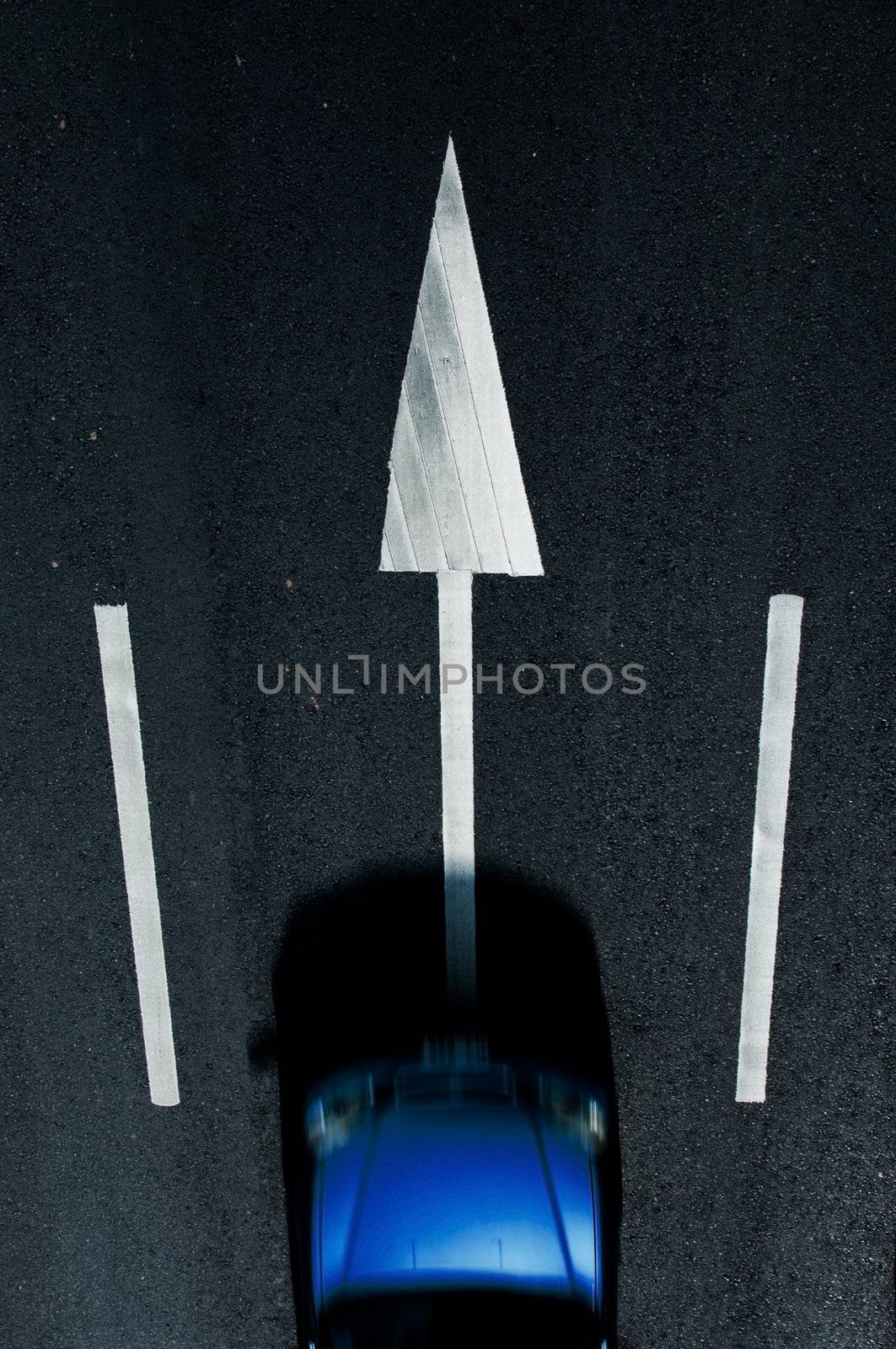 road marking: white arrows  on the dark asphalt road. with  car movement