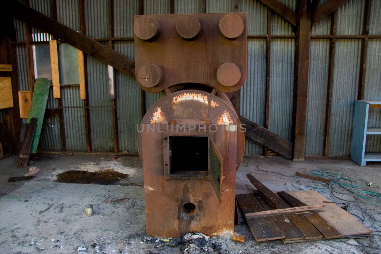 An old instrument at a warehouse stands rusted and unused.