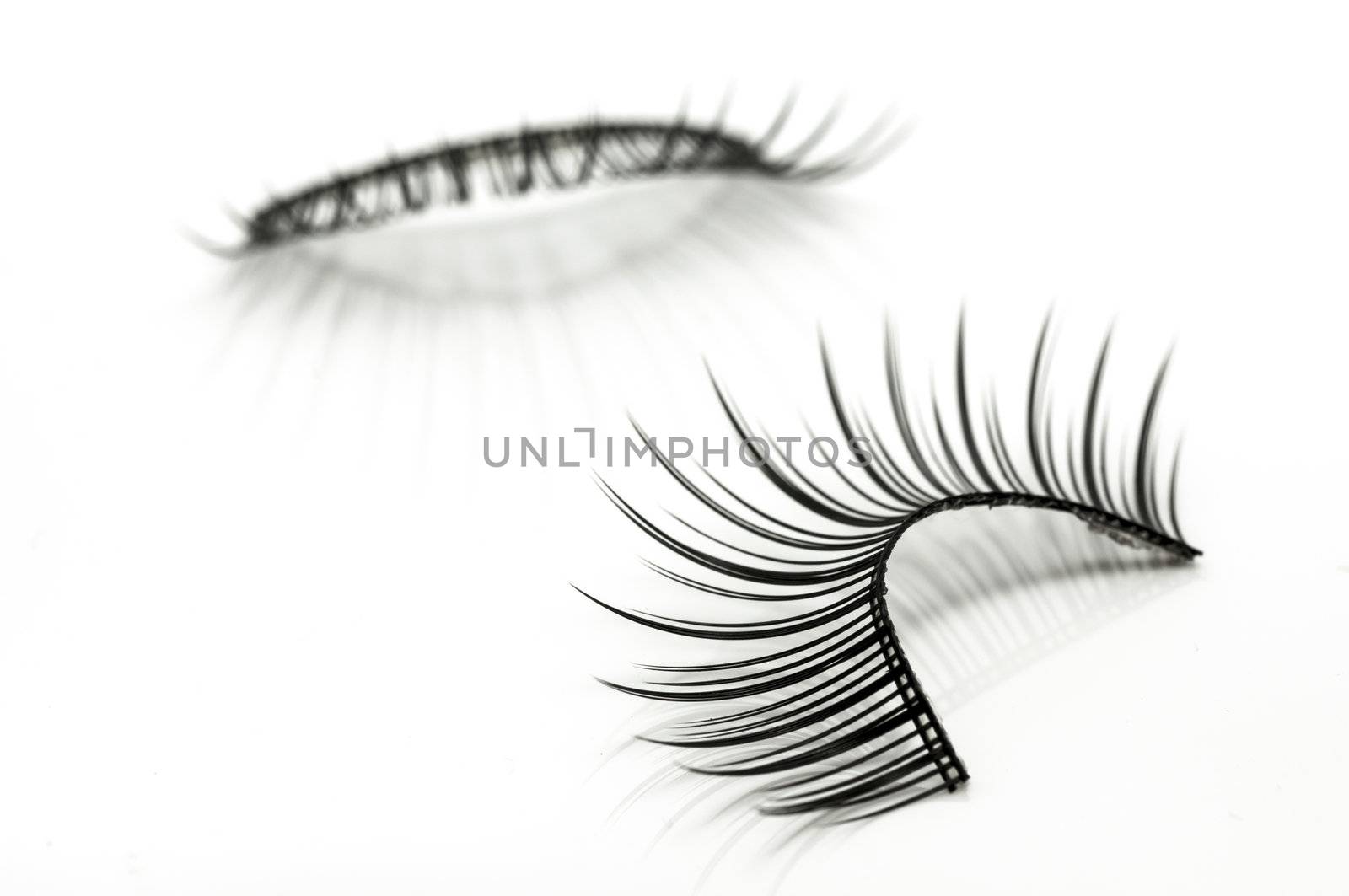 false eyelashes isolated on white by TanawatPontchour